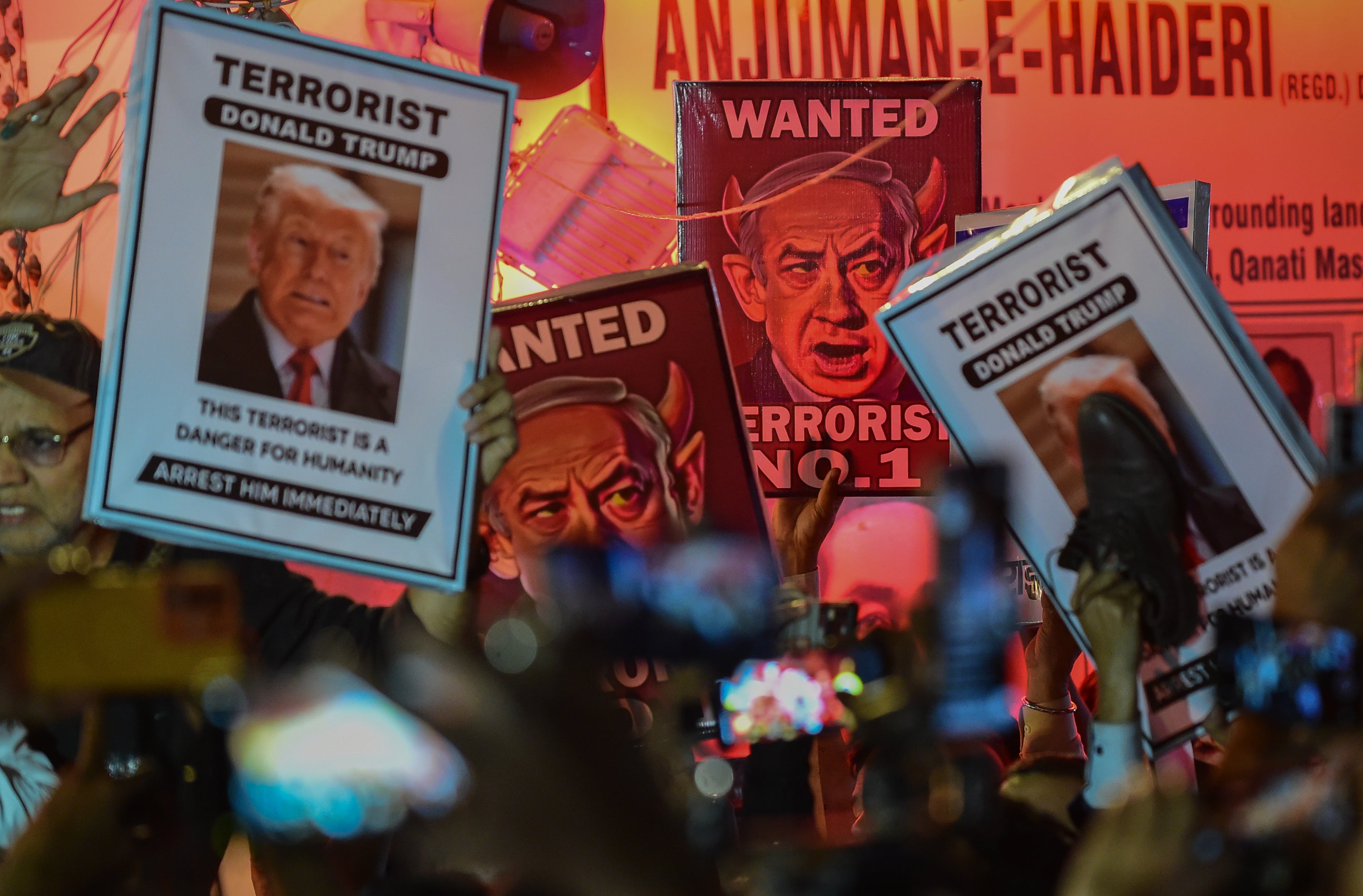 Shia Muslims mourn as they protest with the posters of Israeli prime minister Benjamin Netanyahu and US president Donald Trump in Delhi on 1 March 2026