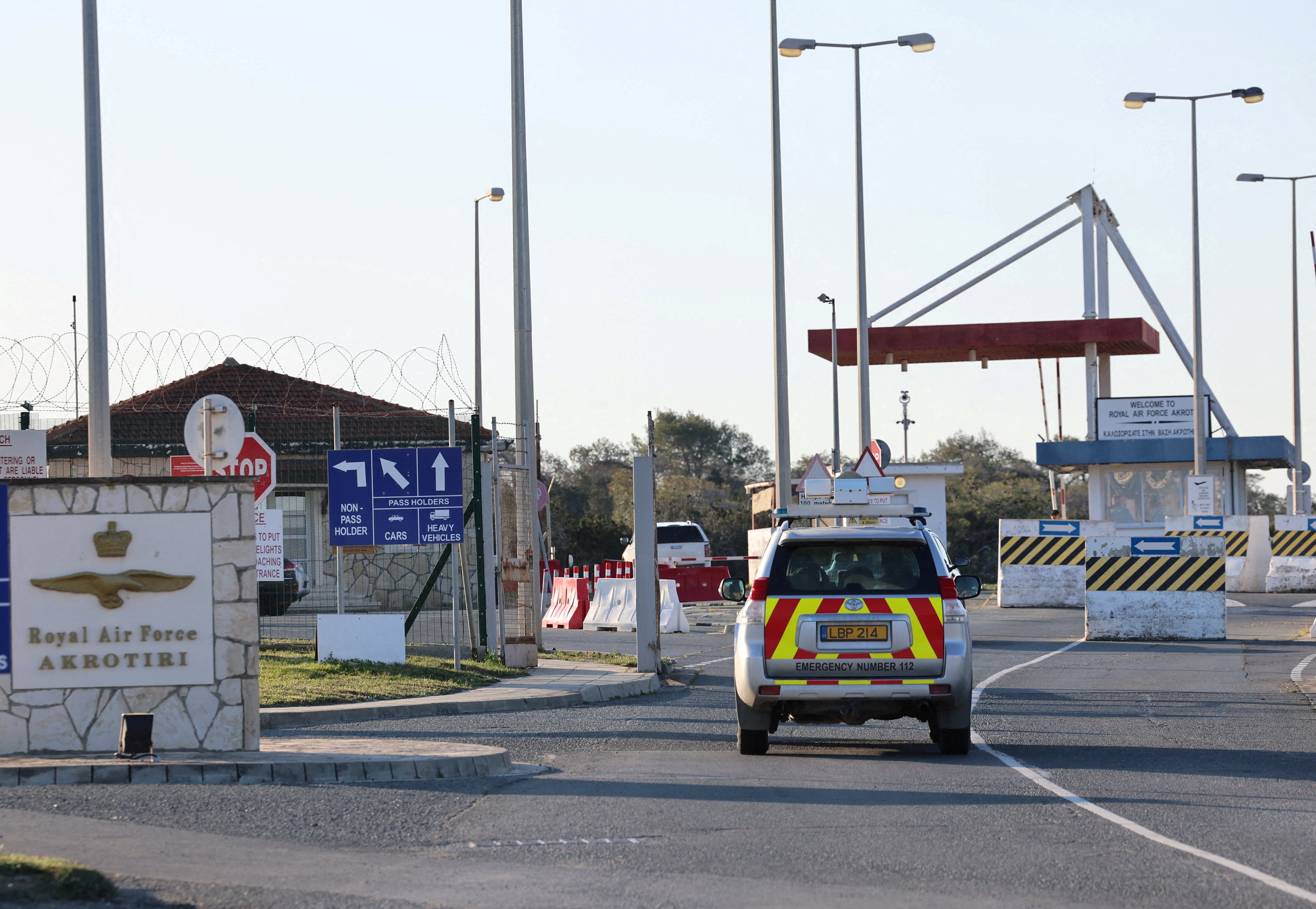 An emergency vehicle passes by the entrance of RAF Akrotiri, a British sovereign base in Cyprus, which was hit by an unmanned drone overnight on Monday
