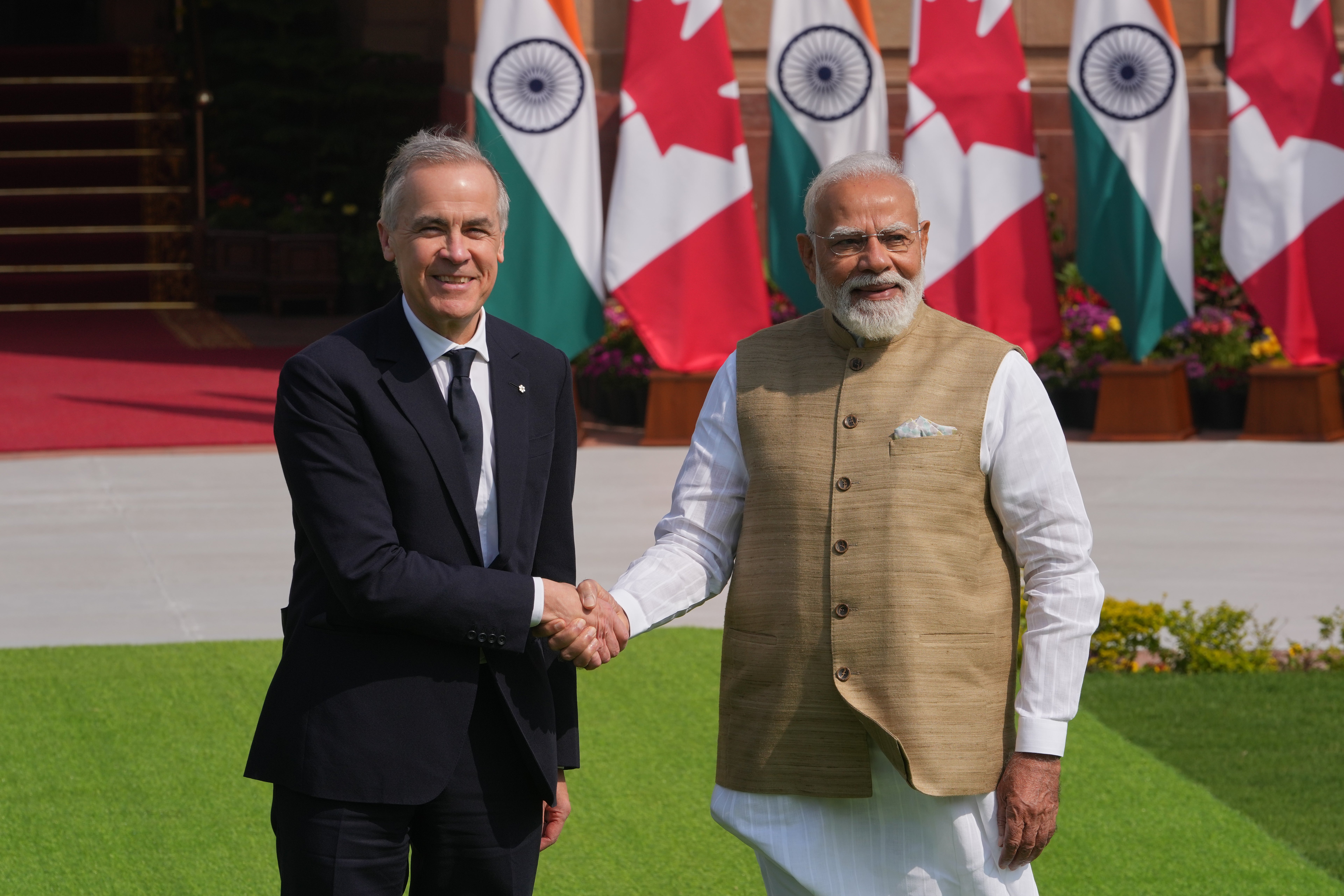 Indian Prime Minister Narendra Modi, right, shakes hands with his Canadian counterpart Mark Carney before their delegation level meeting in New Delhi, India, Monday, March 2, 2026. (AP Photo/Manish Swarup)