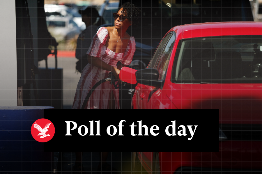 <p>A woman pumps gasoline into her vehicle</p>