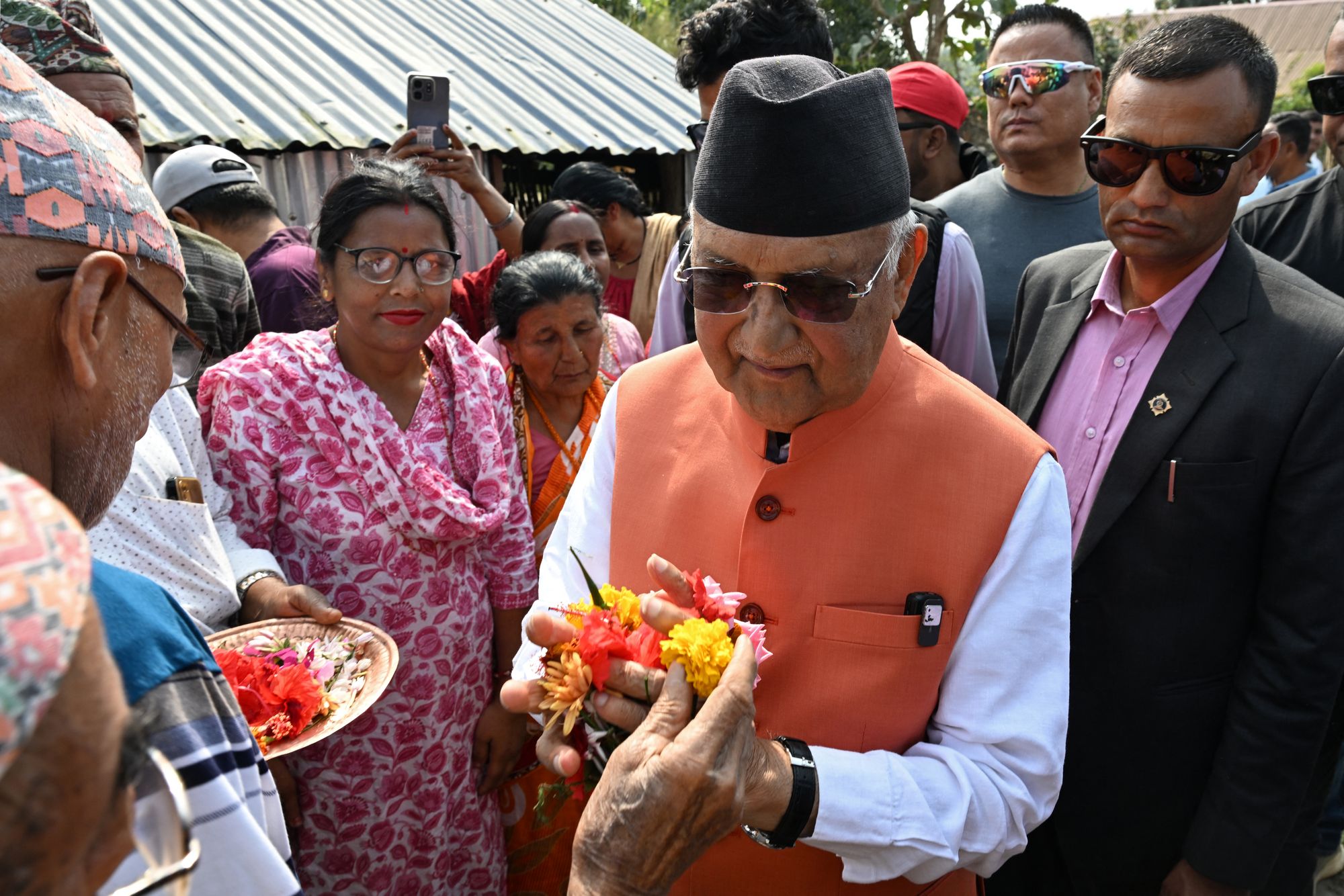 Supporters present flowers to KP Sharma Oli, Nepal's former prime minister, during a rally on the final day of campaigning ahead of the general election at Gauradaha in Jhapa district on 2 March 2026