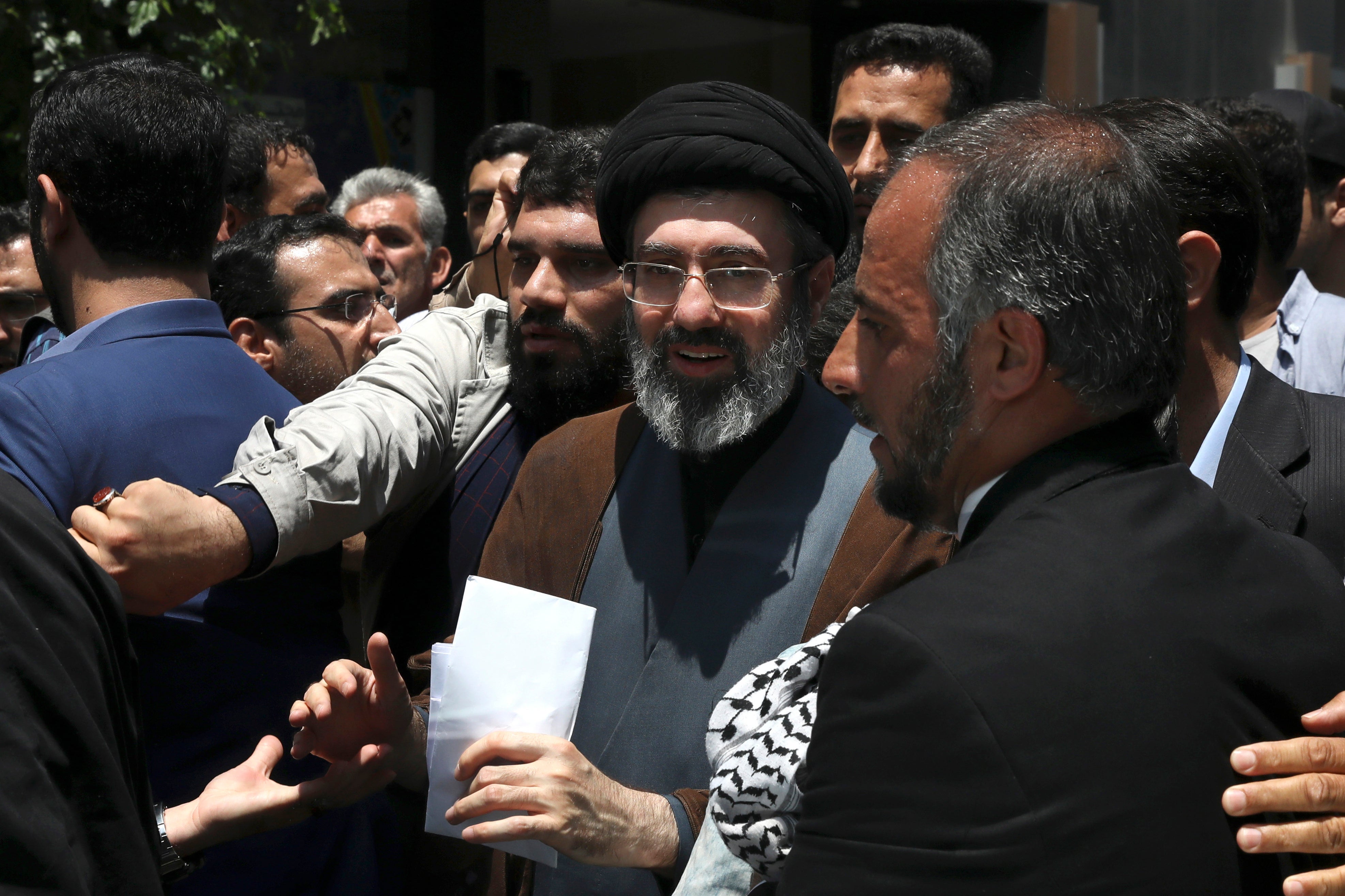 Mojtaba Khamenei (pictured center) is seen as a possible successor to his father