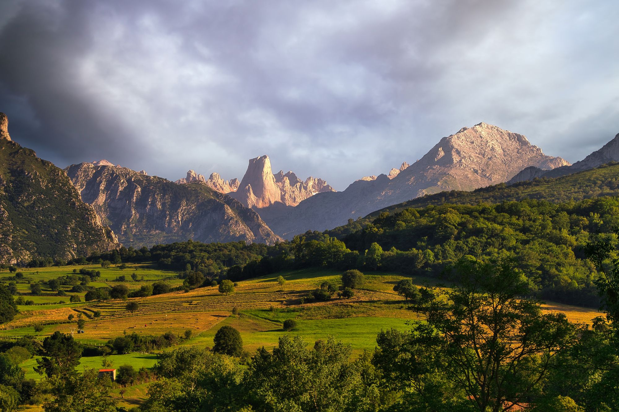 Picu Urriellu (center), widely known as Naranjo de Bulnes, is an 8,264-foot-tall limestone peak in Picos de Europa National Park, famous for its 1,880-foot vertical west face
