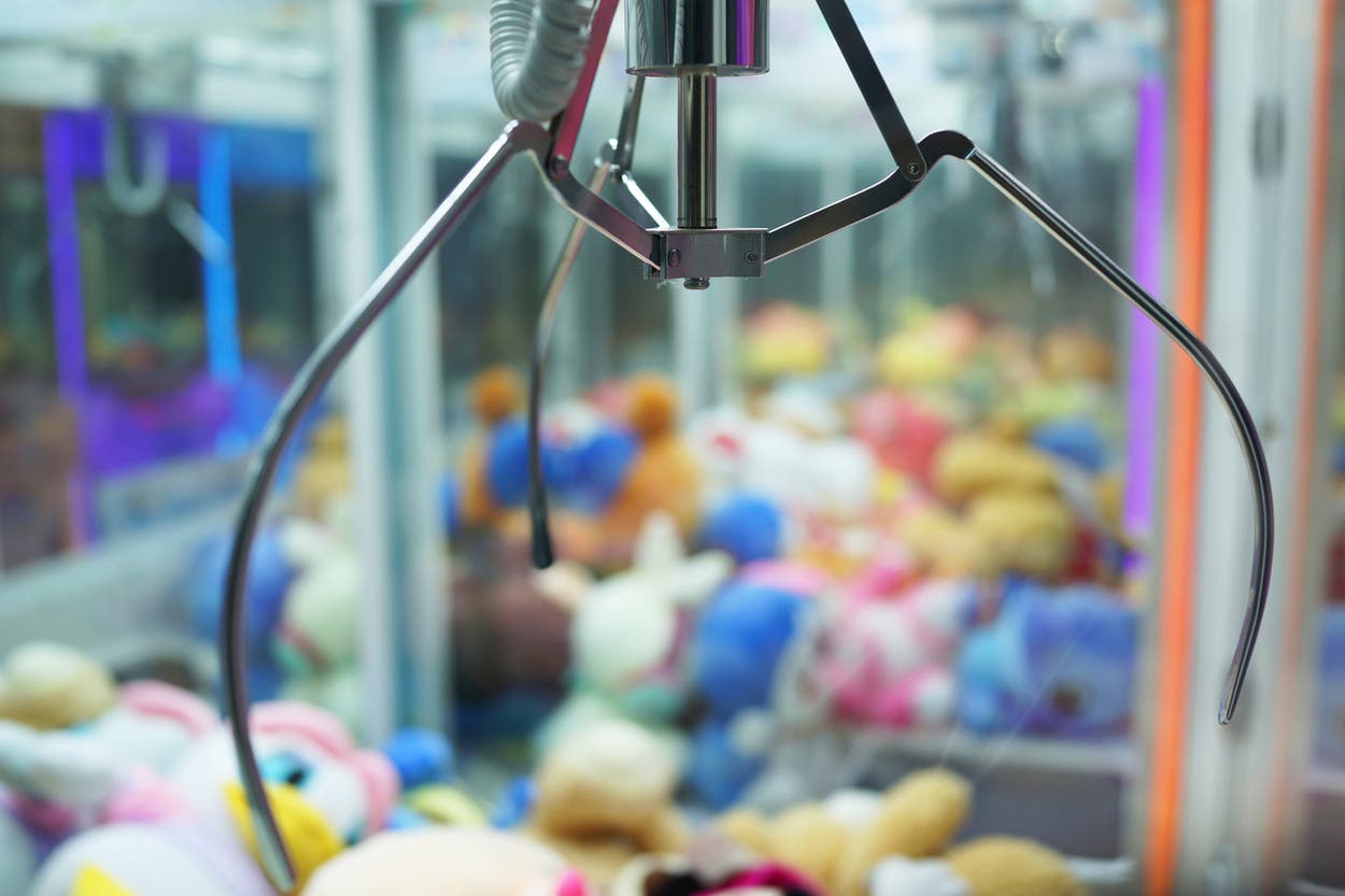 Two children get stuck inside claw machine game after climbing inside ...