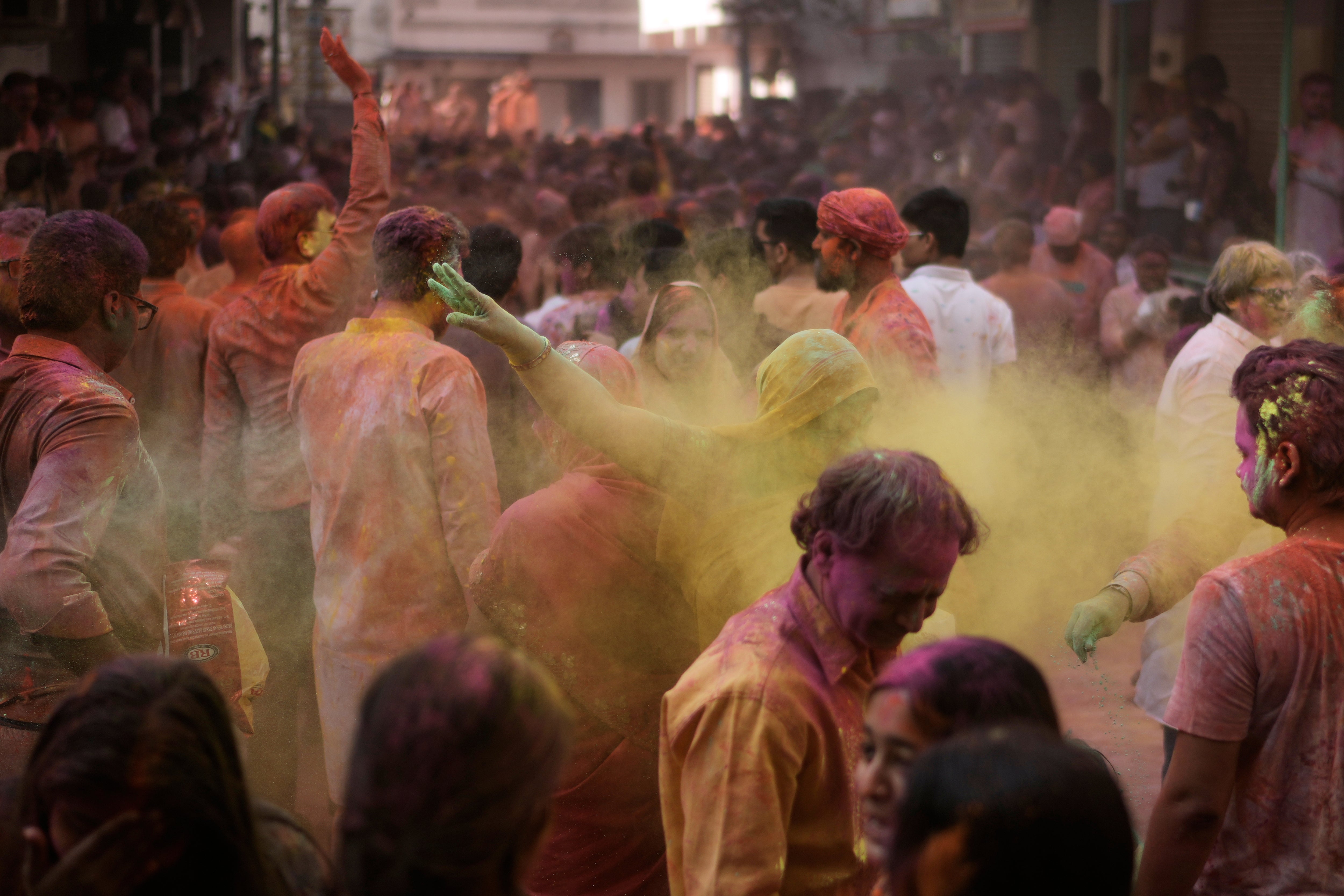 People play with coloured powder as they celebrate Holi in Hyderabad