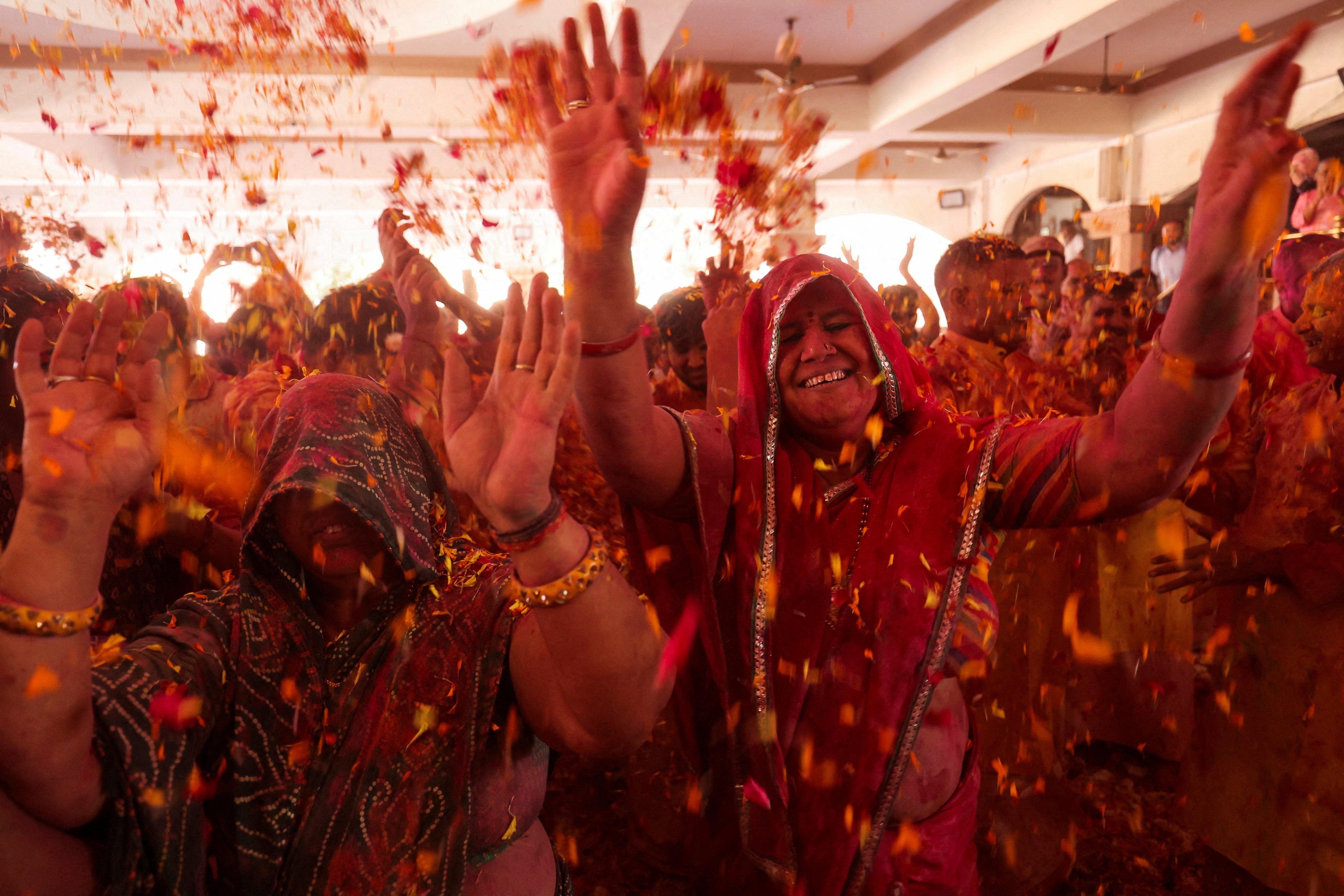 Hindu devotees attend Holi celebrations inside a temple in Ahmedabad