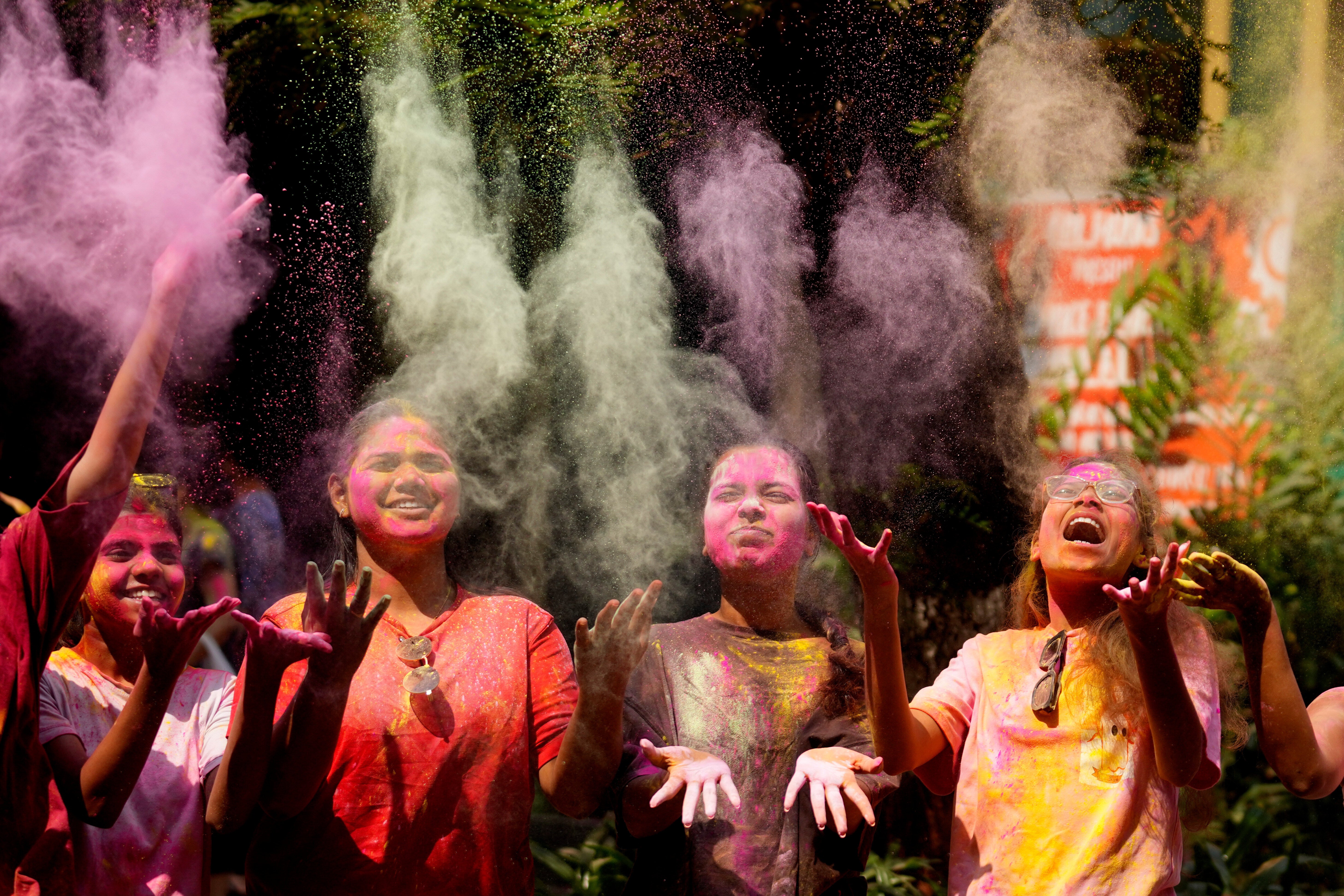 A group of girls pose for photographs as they celebrate Holi in Mumbai