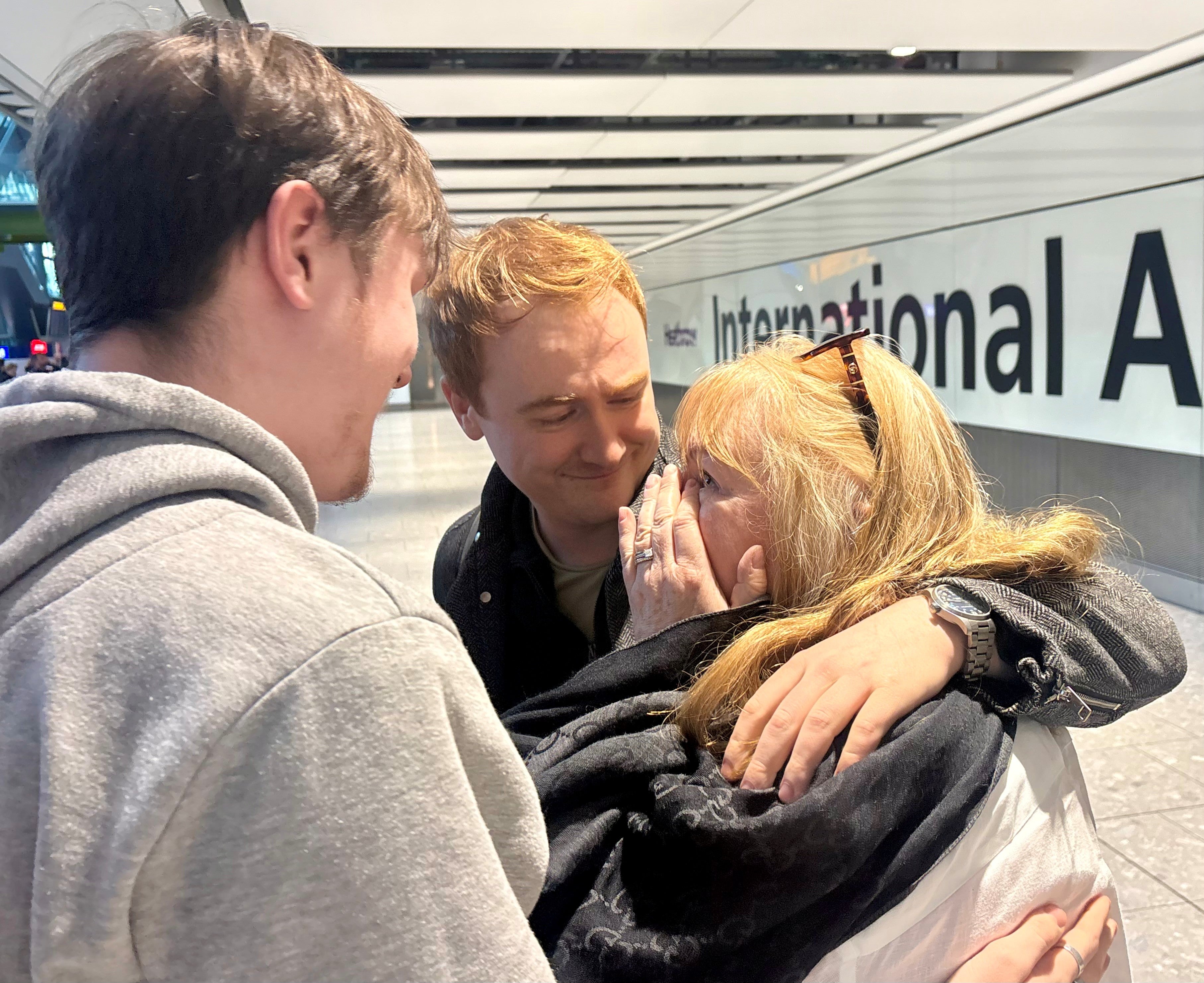 Sarah Short is greeted by her sons Finn (left) and Alex Howard as she arrives at Terminal 5 at London Heathrow Airport on a flight from Muscat
