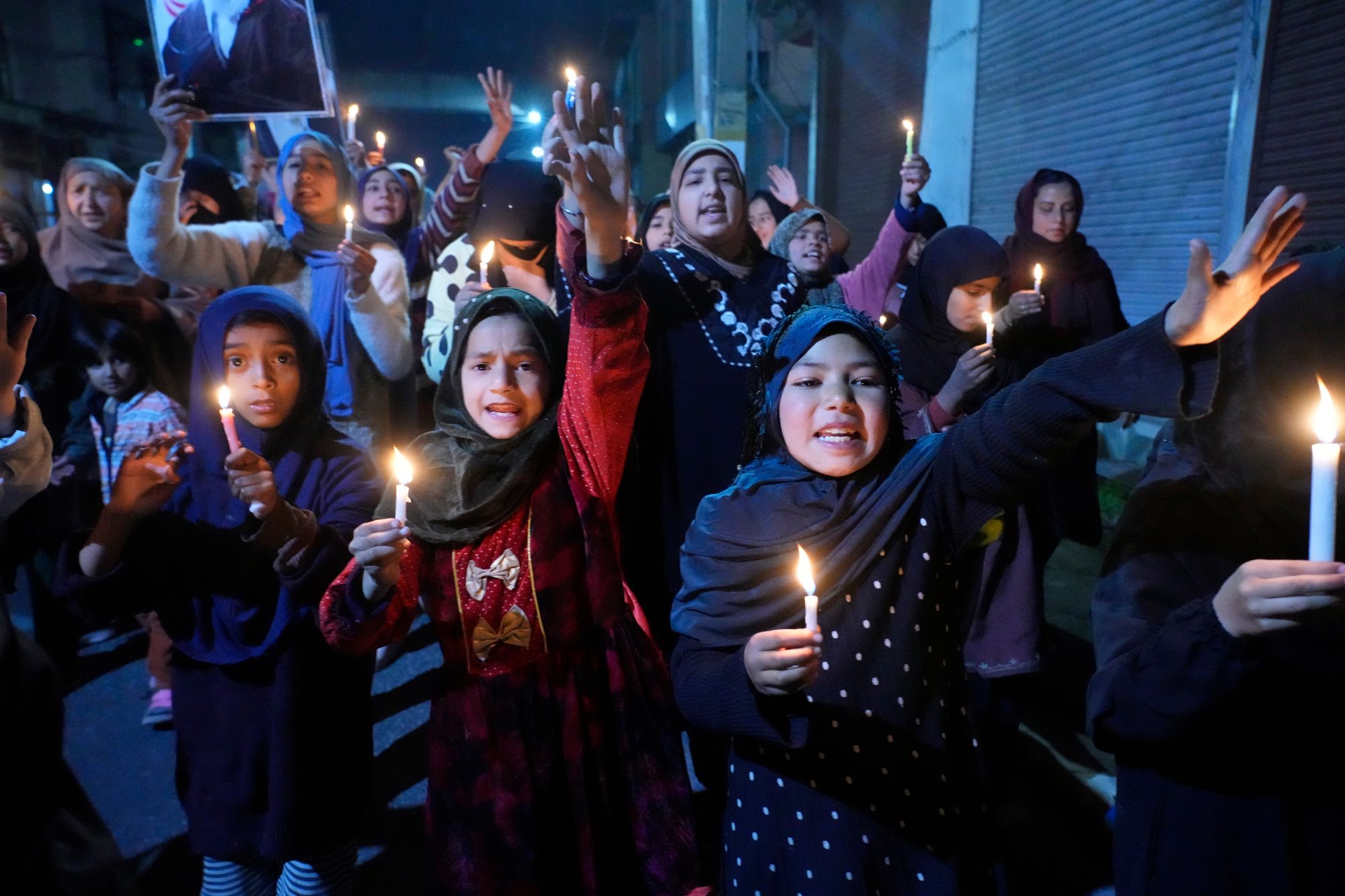 Shiite Muslims shout slogans during a candlelit protest against the killing of Iran's supreme leader Ayatollah Ali Khamenei, in Srinagar, Indian controlled Kashmir, Wednesday, 4 March 2026