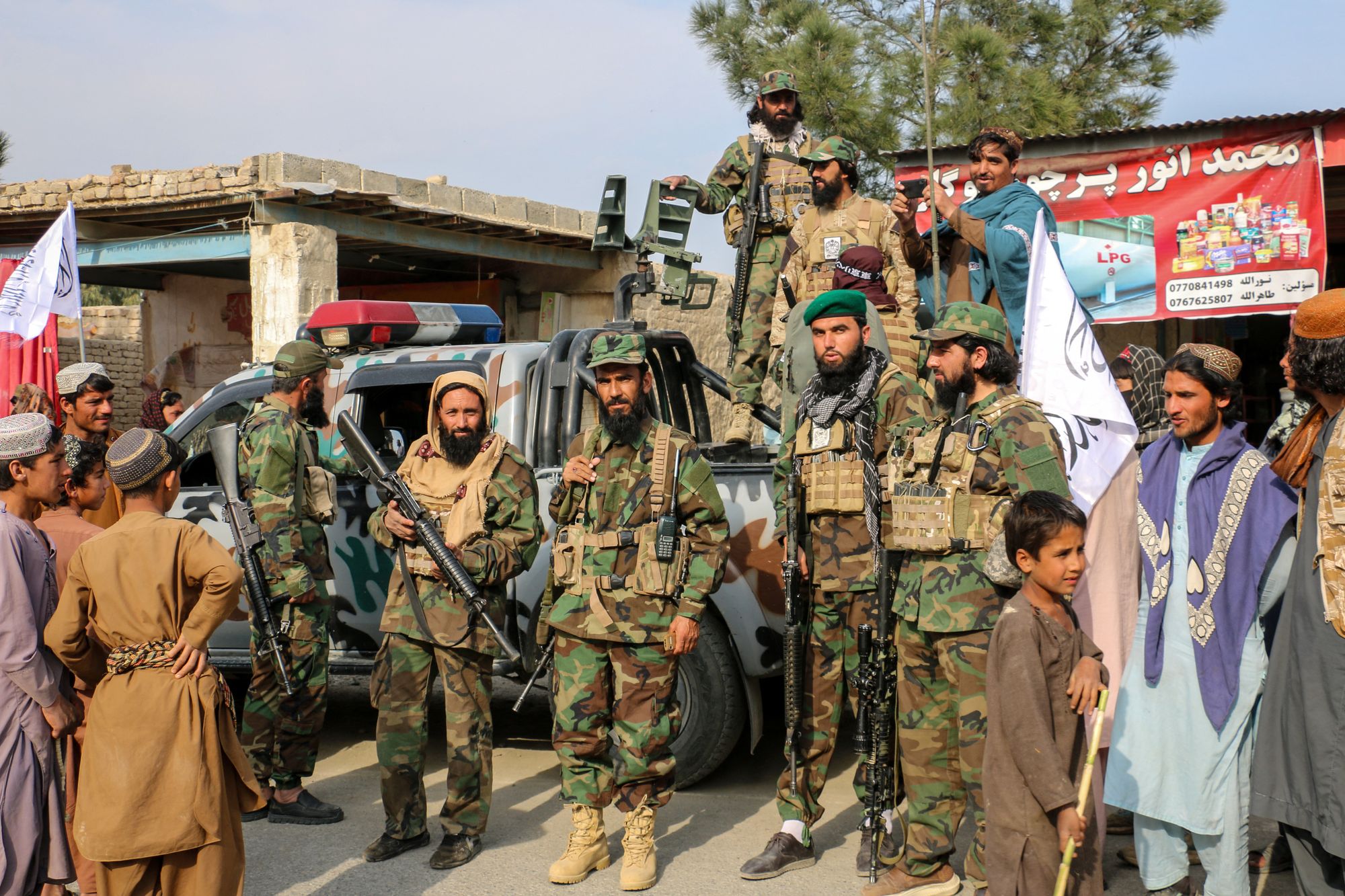 Afghan men welcome Taliban personnel as they gather to show solidarity with them in Gurbuz district, Khost