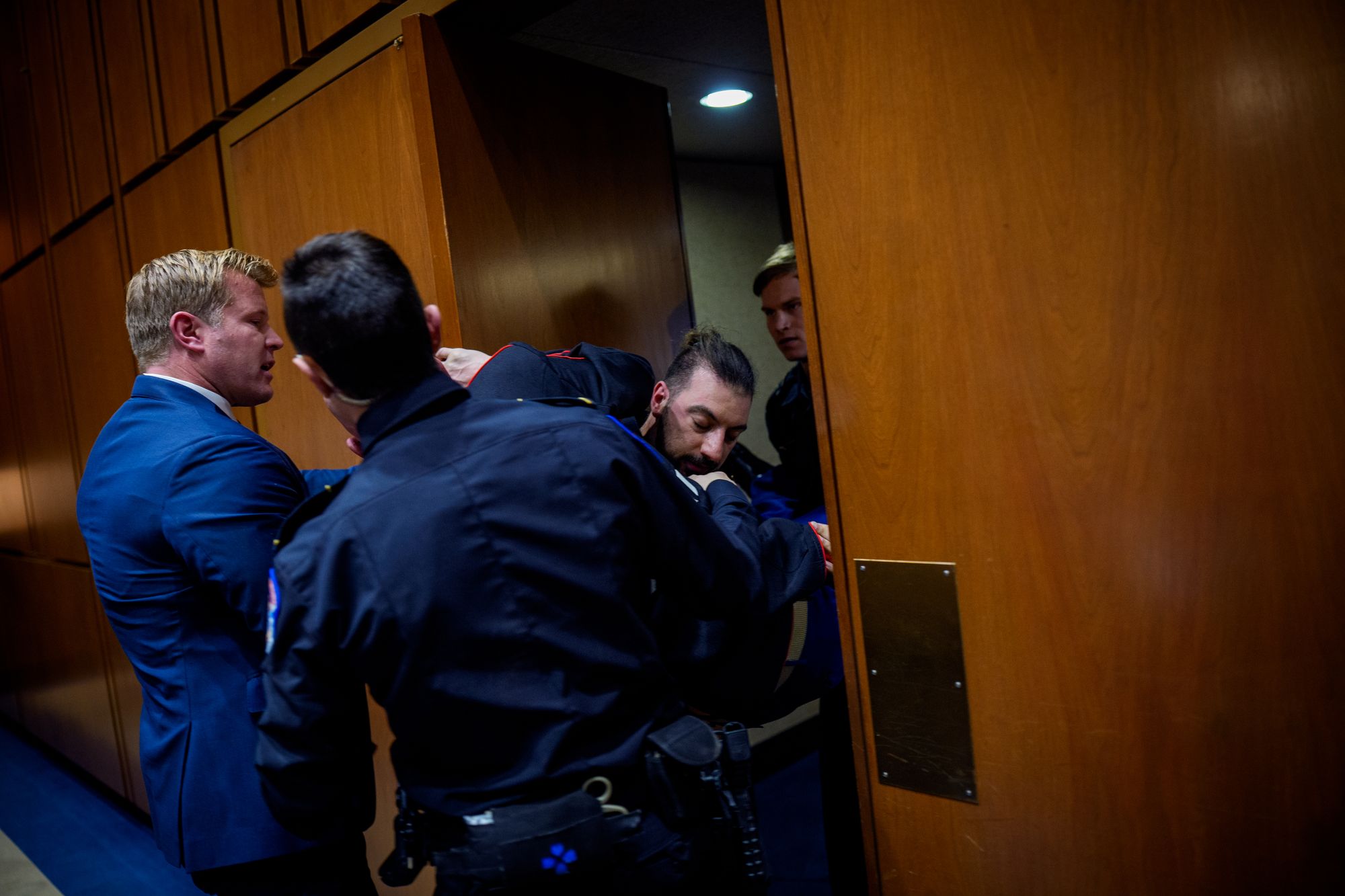 Sen. Sheehy and Captiol Police officers attempted to remove McGinnis from the Senate Armed Forces Committee hearing