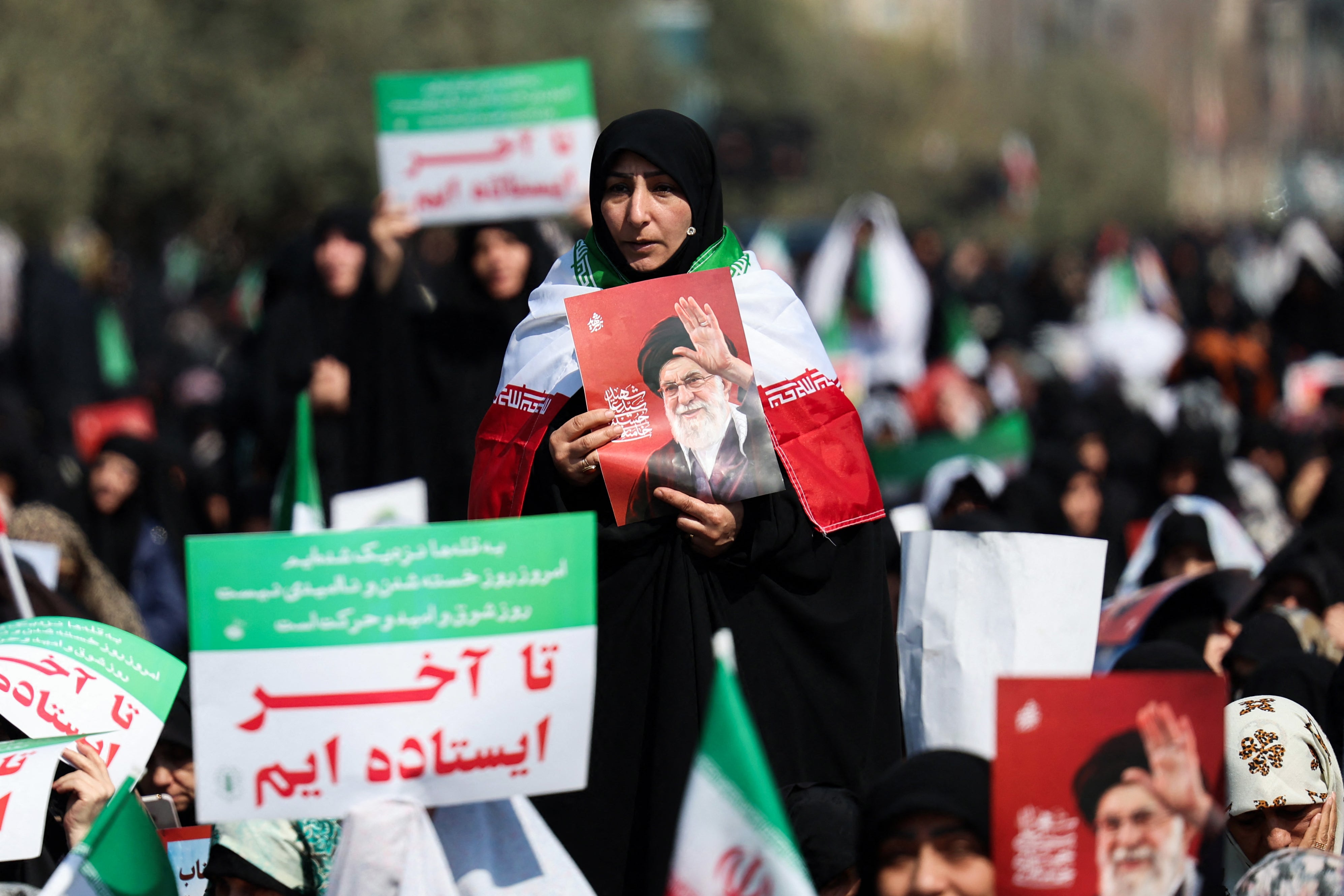Women hold posters of Khamenei during noon prayers at the Mosalla mosque in Tehran