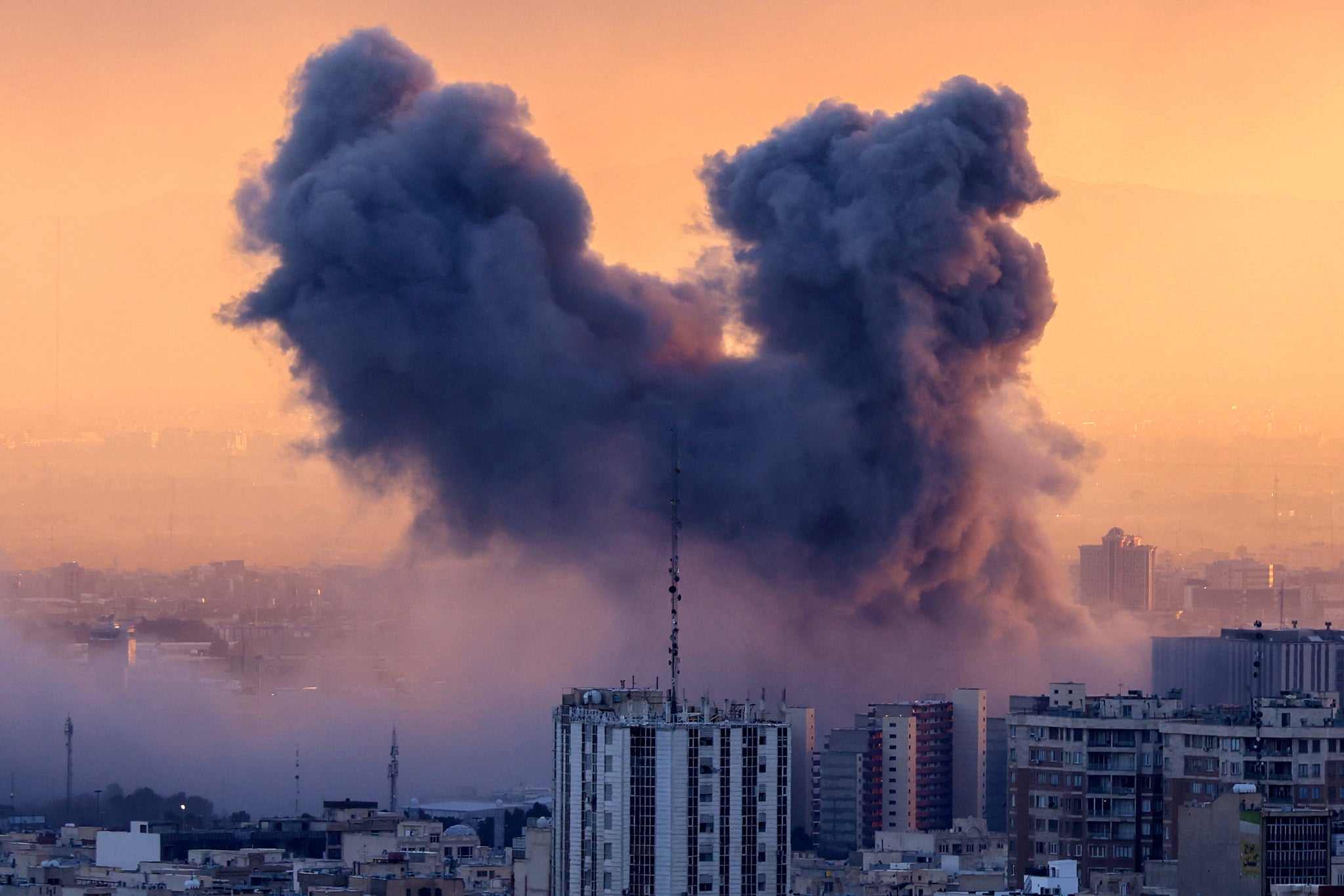 A plume of smoke rises after a strike on the Iranian capital Tehran on Tuesday