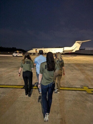FBI agents escort Zobaidul Amin to an airplane in Kuala Lumpur, Malaysia, on Wednesday, March 4, 2026, for transport to Anchorage, Alaska, where he faces charges of child pornography and exploitation. (U.S. Department of Justice via AP)