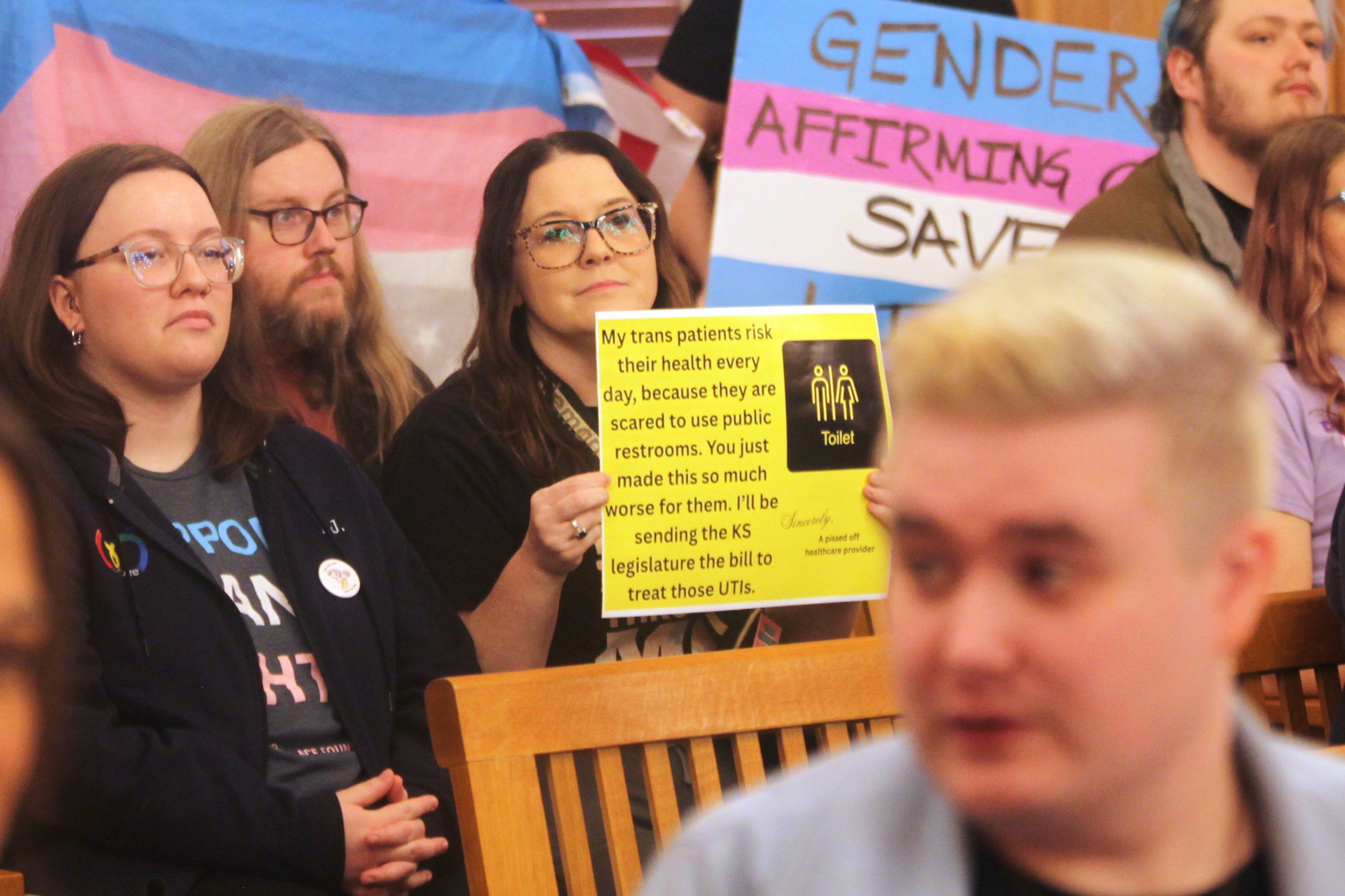 Trans rights supporters protest against S.B. 244 during a sit-in at a legislative committee hearing in Topeka, February 6, 2026. Republicans used a controversial procedure known as ‘gut and go’ to insert new provisions into an existing bill, allowing it to be pushed through rapidly without the usual debate and scrutiny