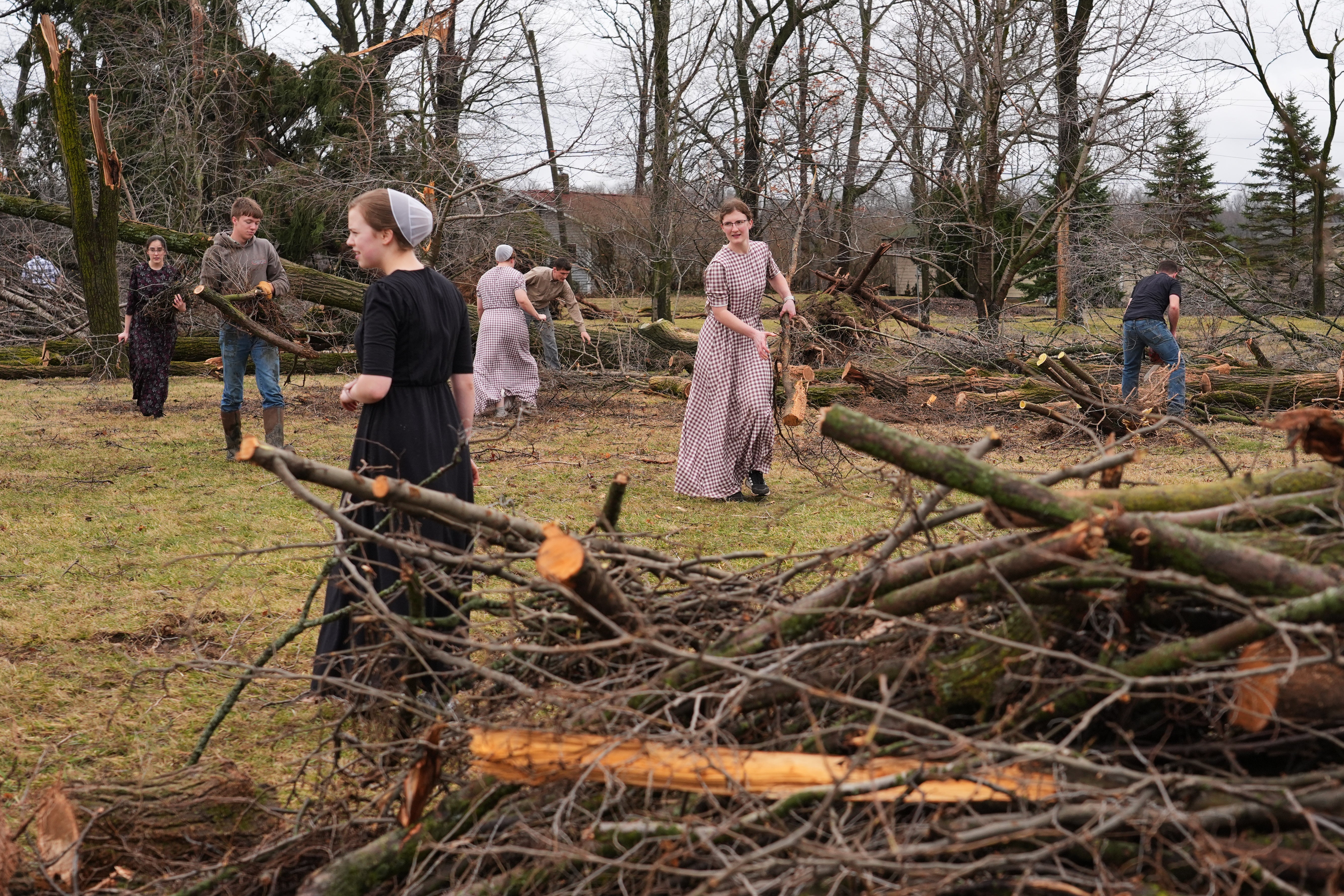 Volunteers work to clear branches felled by a storm a day earlier in Union City, Michigan