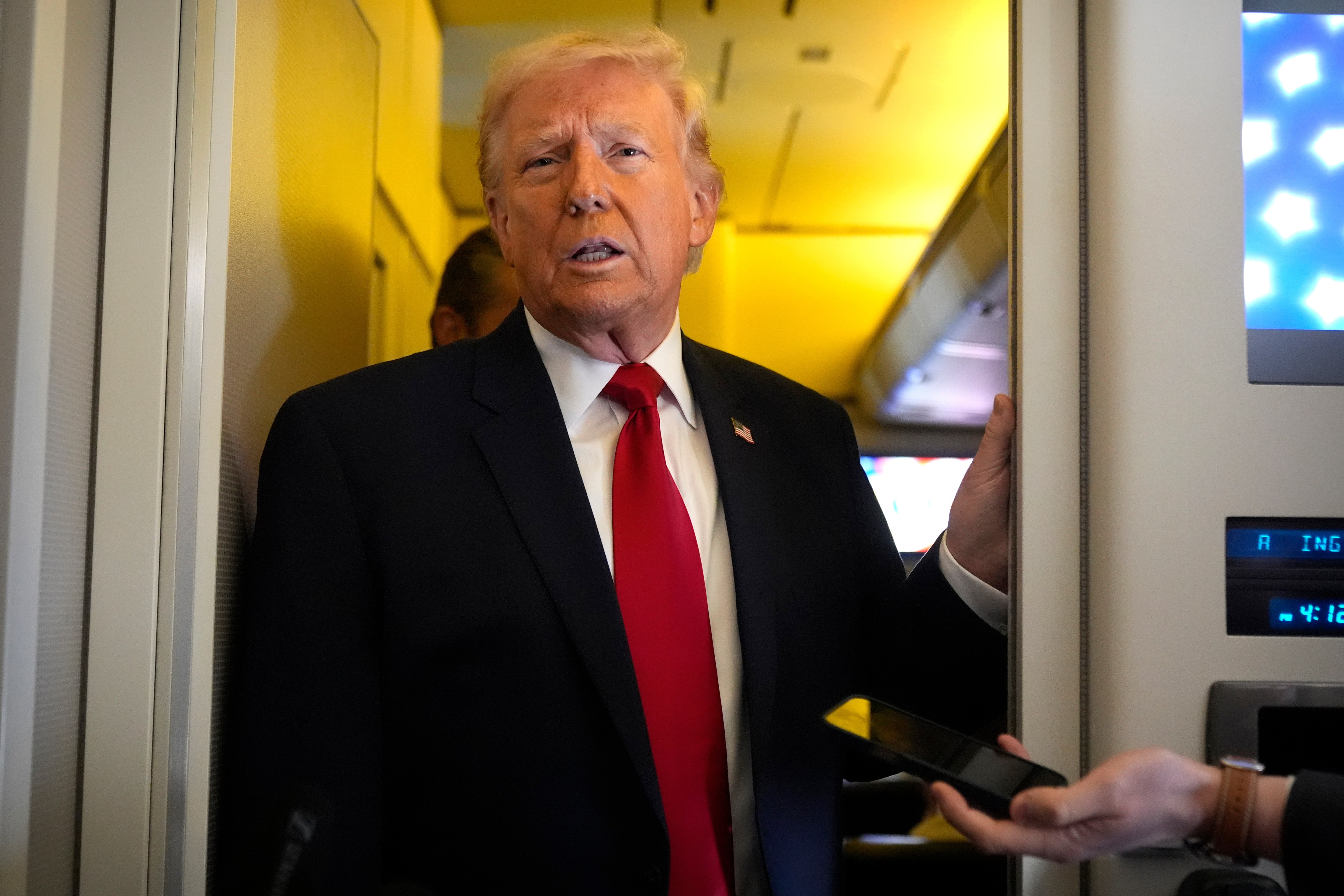 Donald Trump speaks to reporters (Mark Schiefelbein/AP)