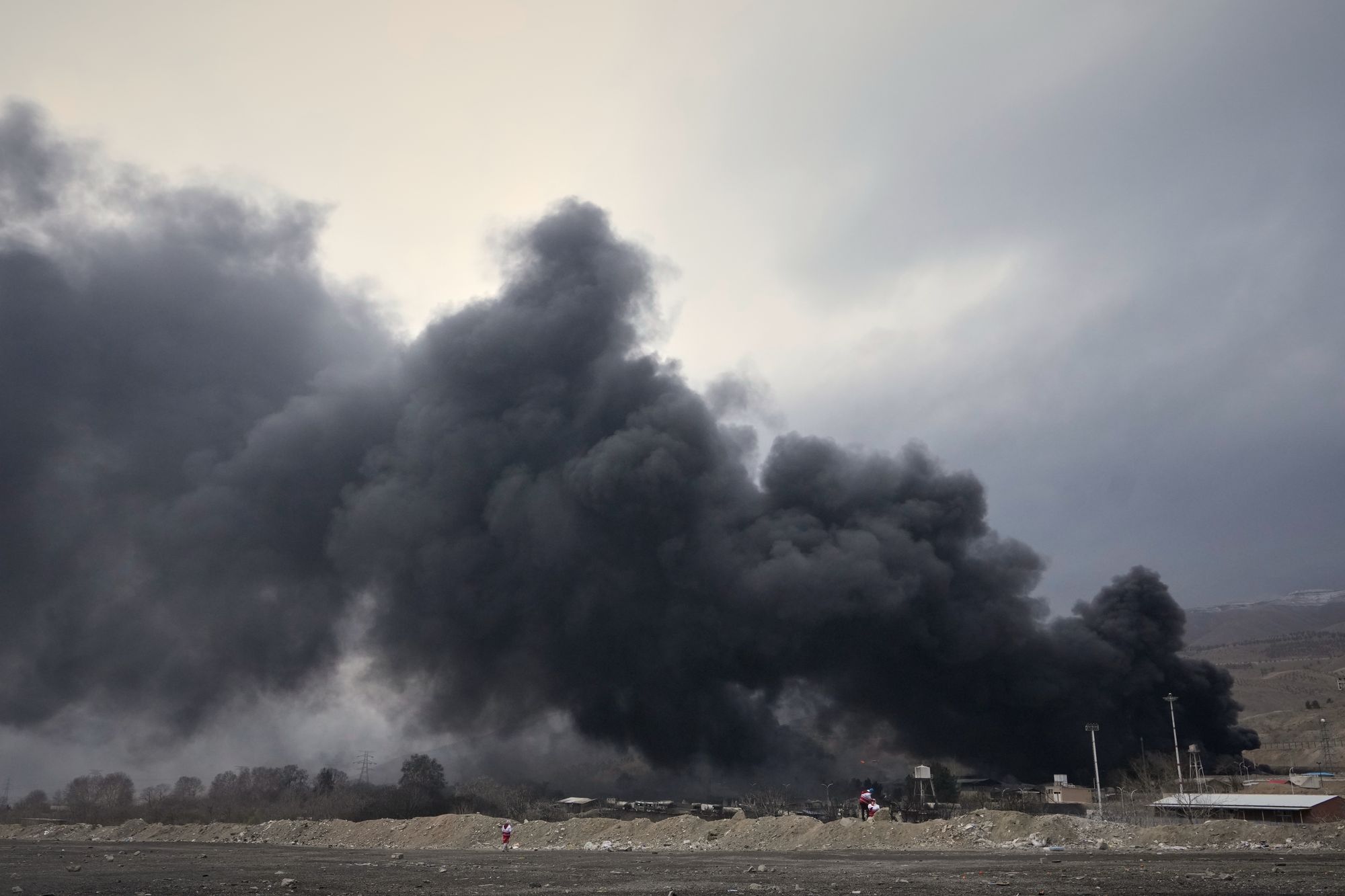 A thick plume of smoke from a US-Israeli strike on an oil storage facility lingers in the sky over Tehran on Sunday