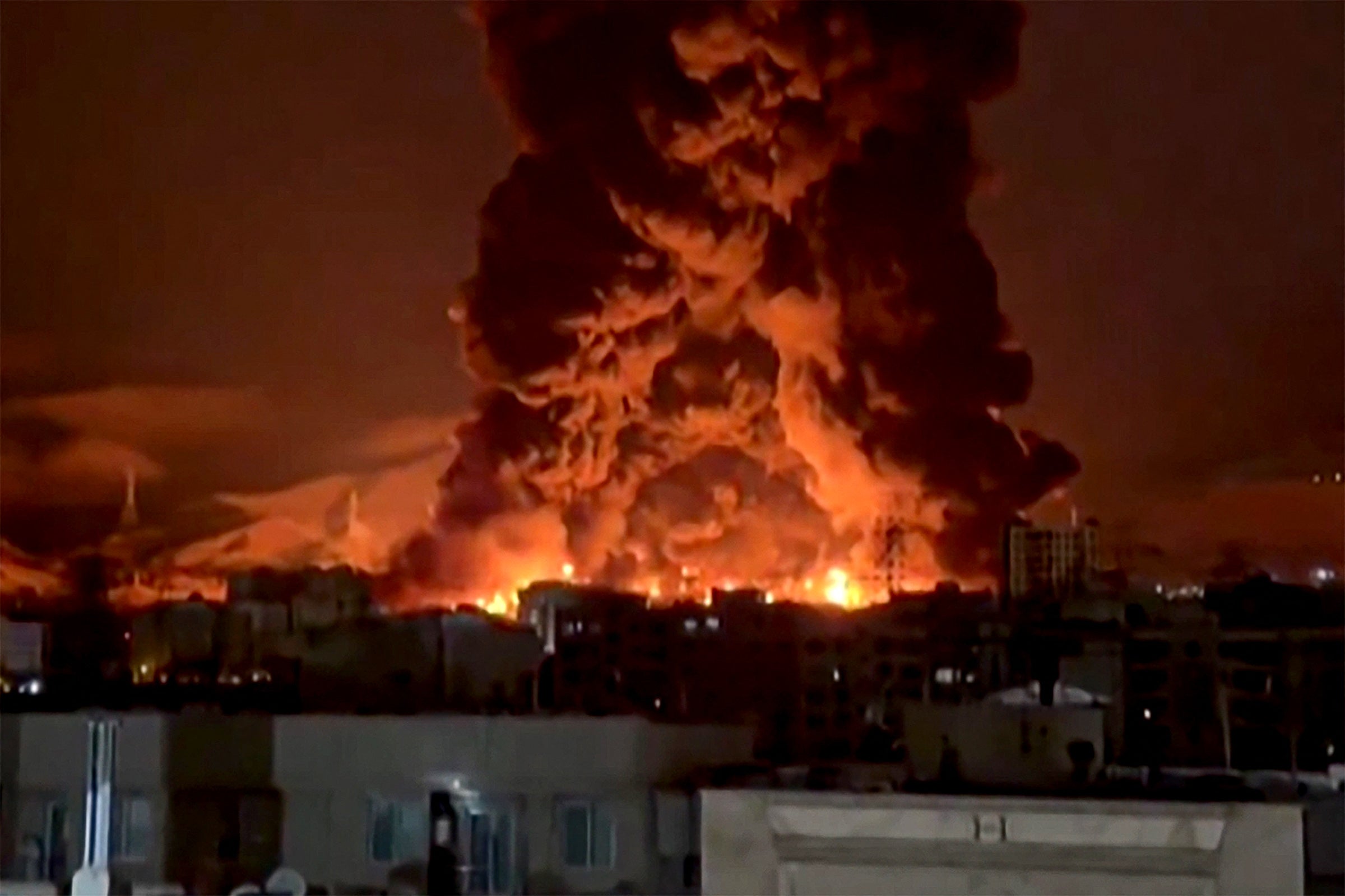 This video grab taken from UGC images posted on social media on March 7 and 8, 2026 shows fire erupting at an oil depot in Iran's capital Tehran. The United States and Israel launched strikes against Iran