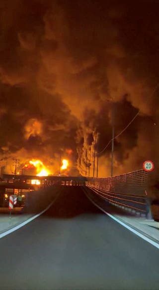 Fire burns and smoke rises from Aqdasieh Oil Depot after being reportedly hit by strike in Tehran
