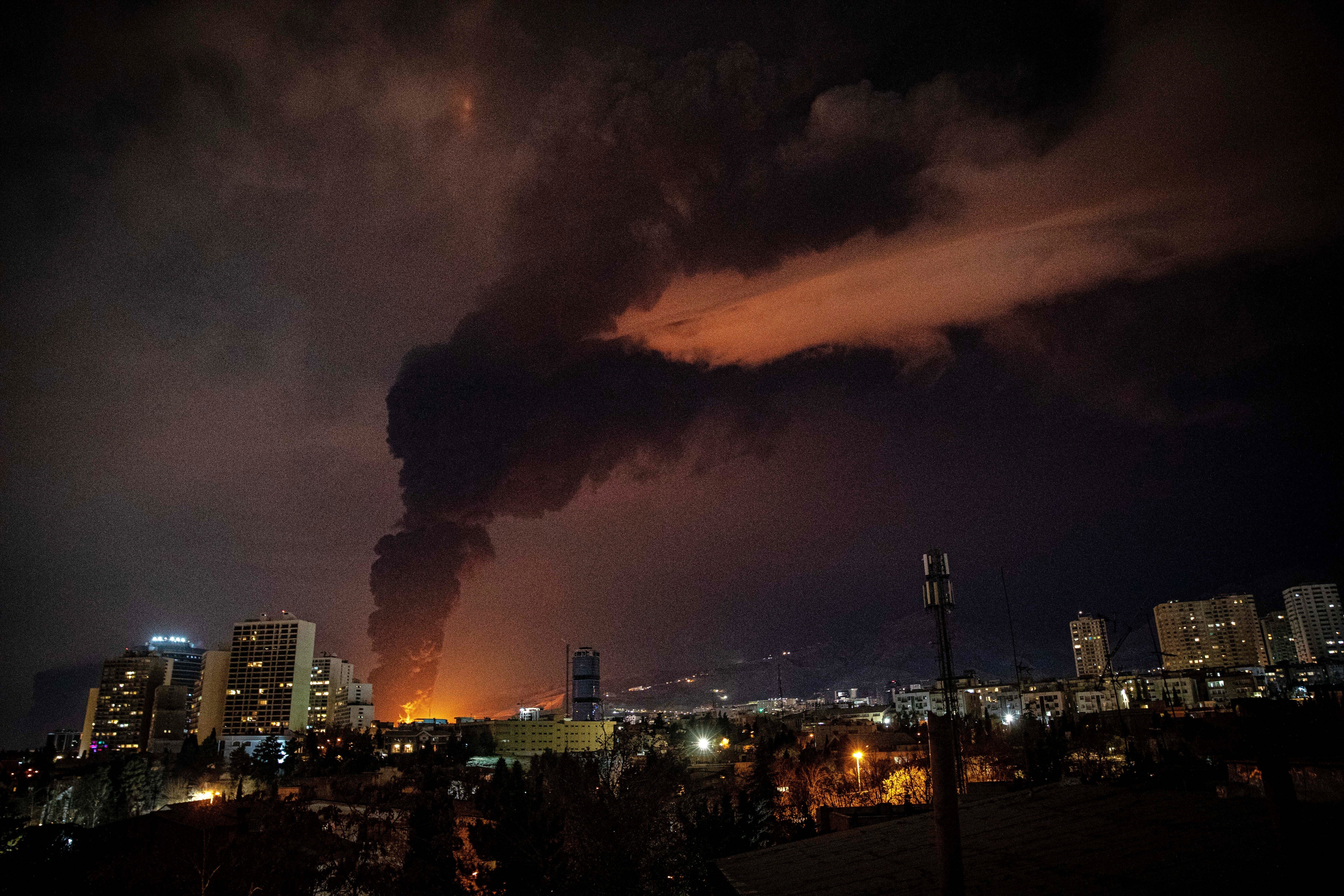 Flames and smoke rise from an oil storage facility in Tehran