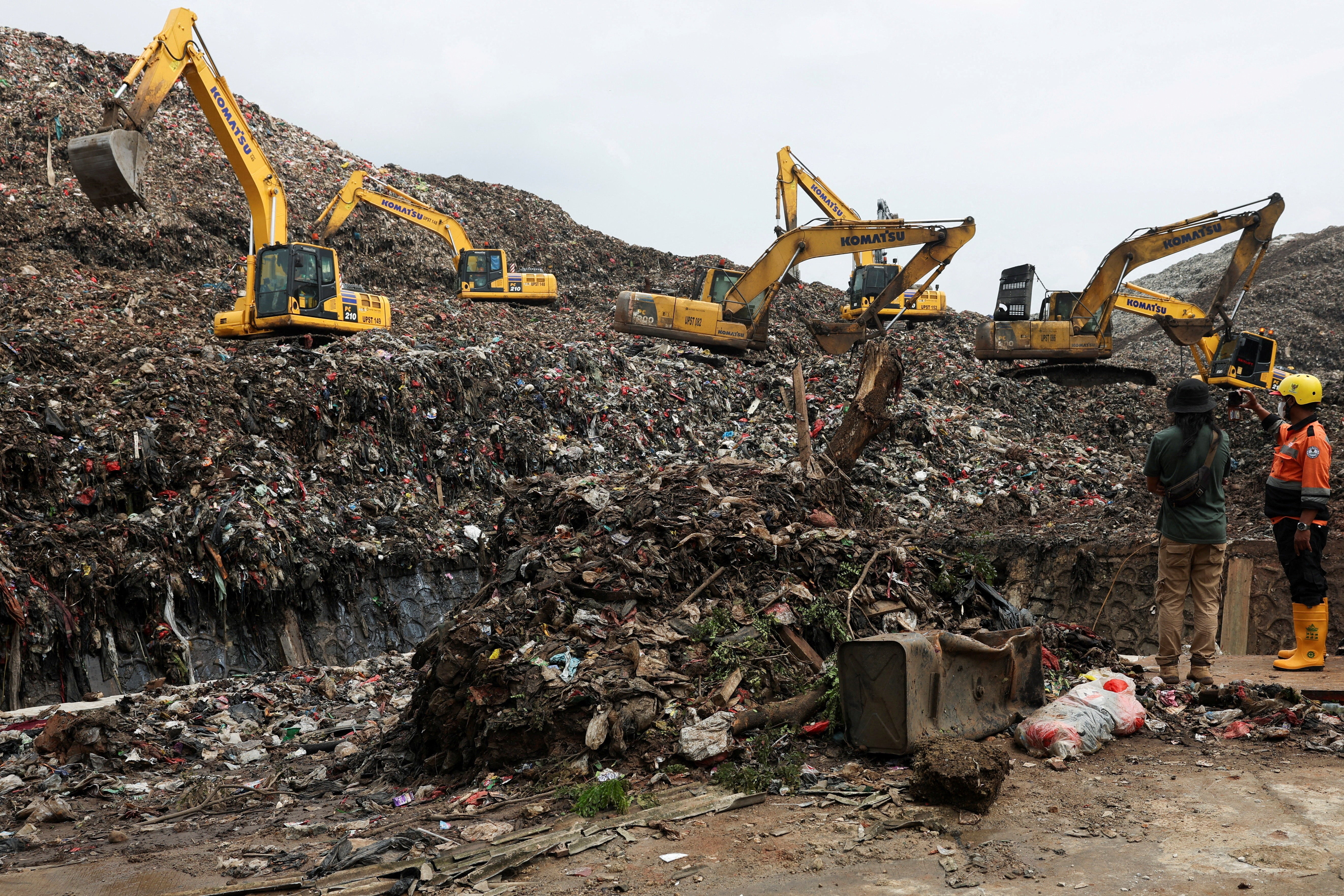 Excavators operate amid garbage at the site of a collapse at Bantar Gebang landfill during a rescue operation in Bekasi, on the outskirts of Jakarta