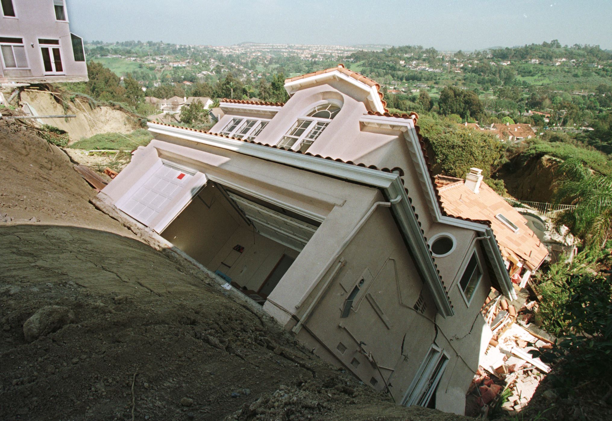 A luxury home in Orange County in the L.A. metro area slips down an eroded hillside on March 19, 1998, following heavy El Niño rains earlier in the month