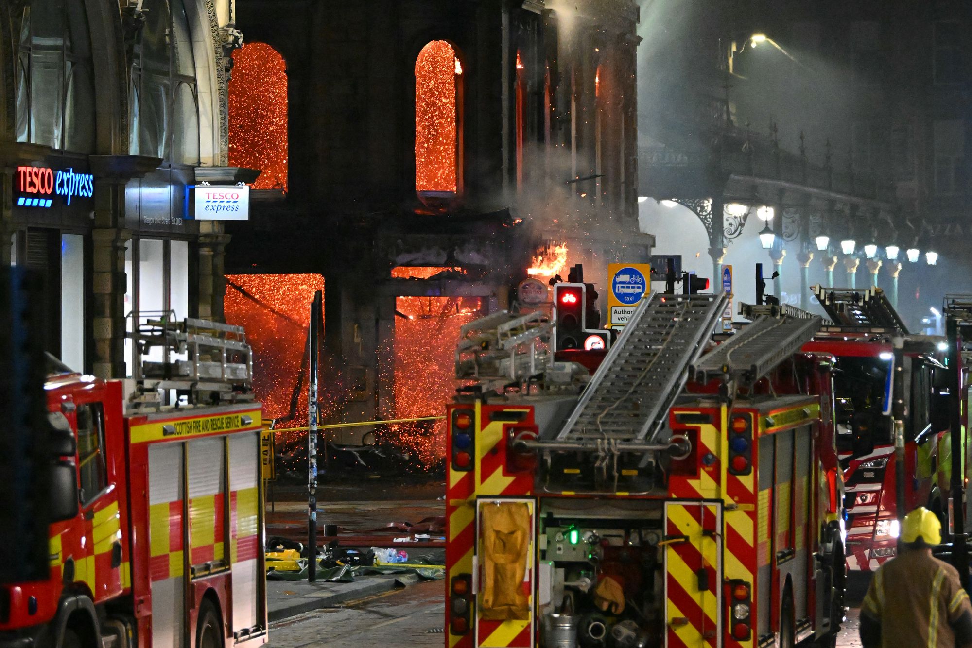 Floors collapse inside the building as fire fighters work at the site of a large fire in Glasgow City centre