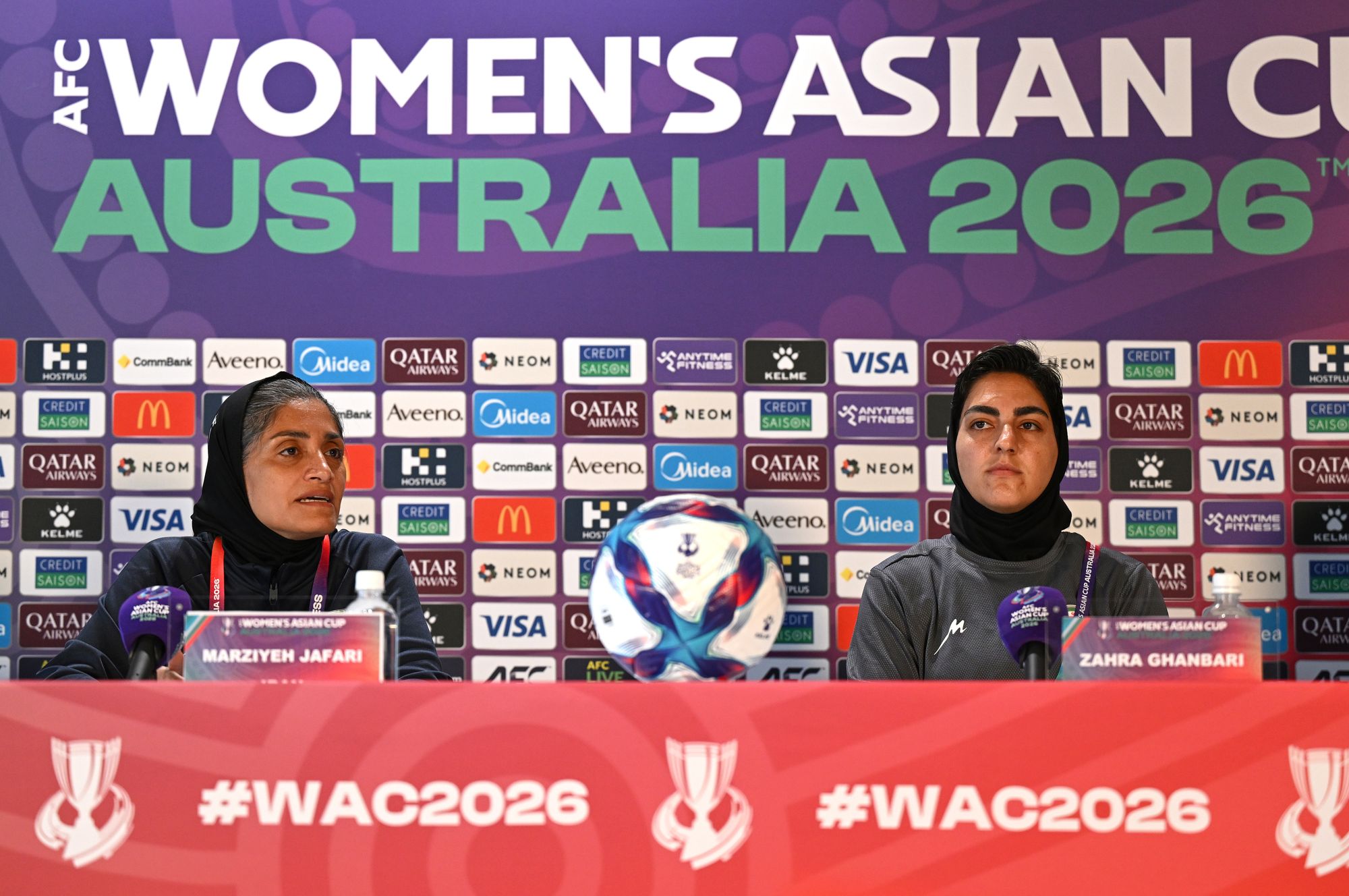 Iranian women’s national football team coach Marziyeh Jafari, left, and captain Zahra Ghanbari, react during a press conference ahead of their game against South Korea at Robina Stadium on the Gold Coast
