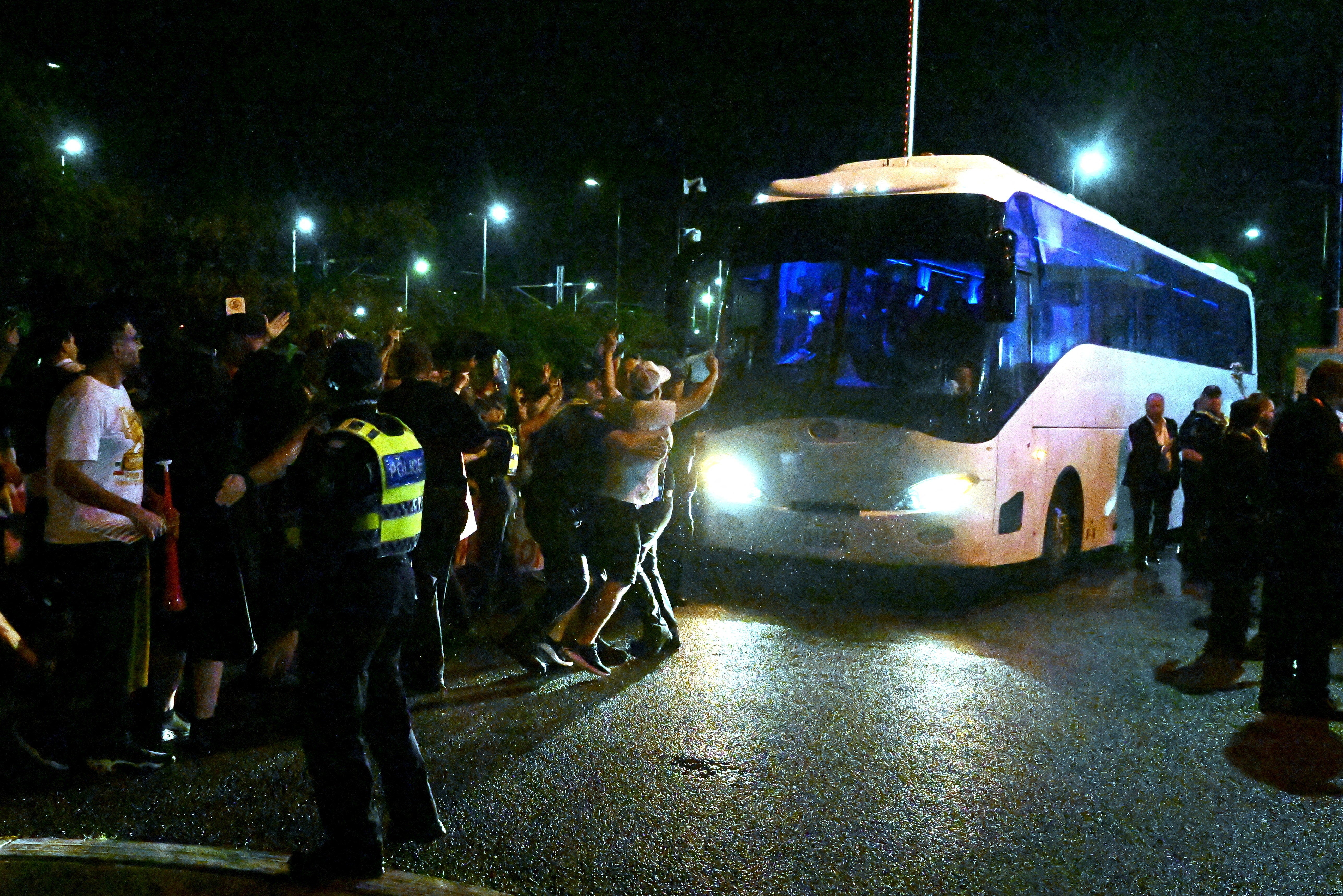 People attempt to block a bus transporting Iranian players following the AFC Women's Asian Cup Group A match between Iran and the Philippines at Gold Coast Stadium in Australia on Sunday