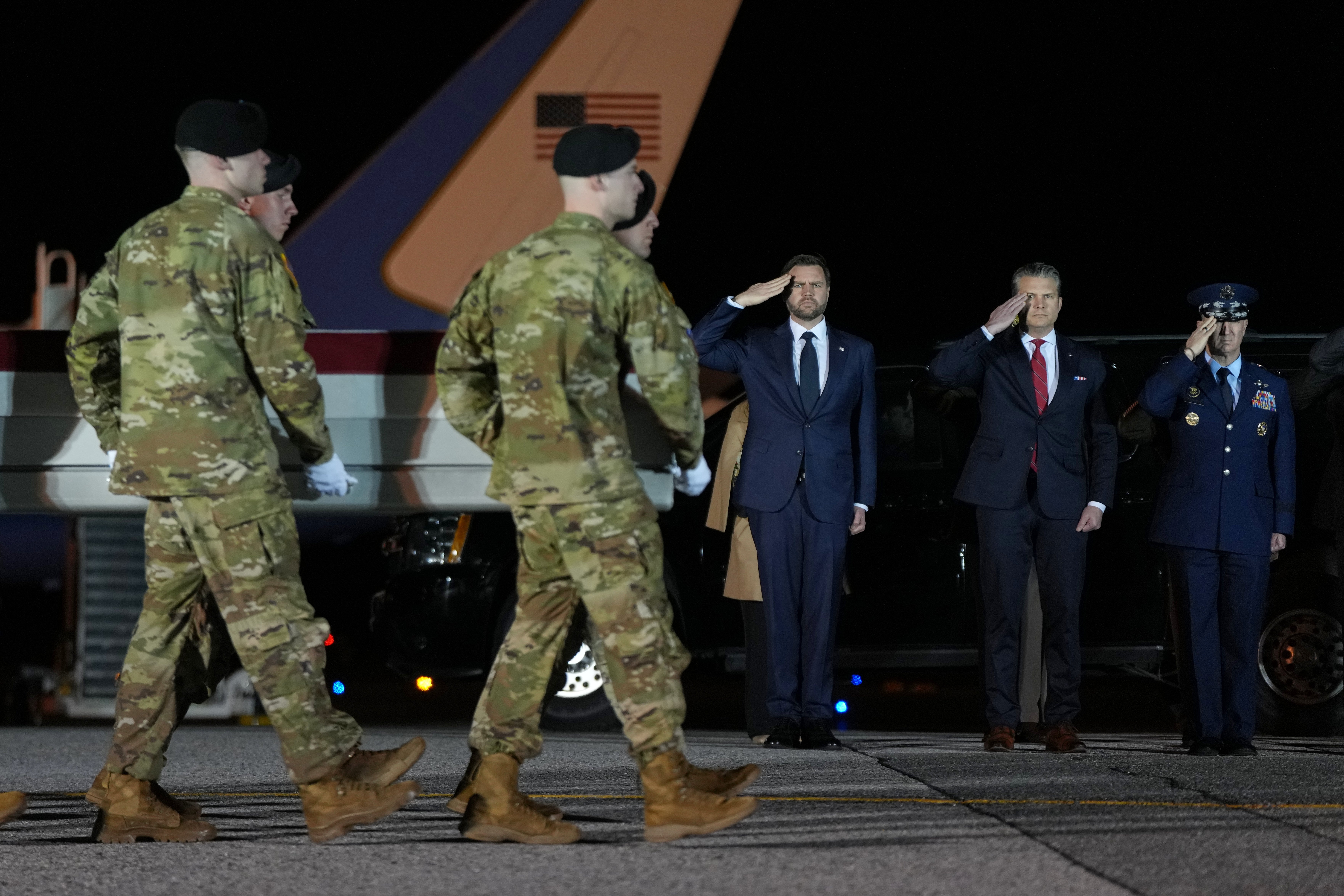 Vice president JD Vance, defence secretary Pete Hegseth and chairman of the joint chiefs of staff Gen Dan Caine salute as a US Army carry team moves the transfer case containing the remains of Sgt Benjamin Pennington at Dover Air Force Base, in Delaware