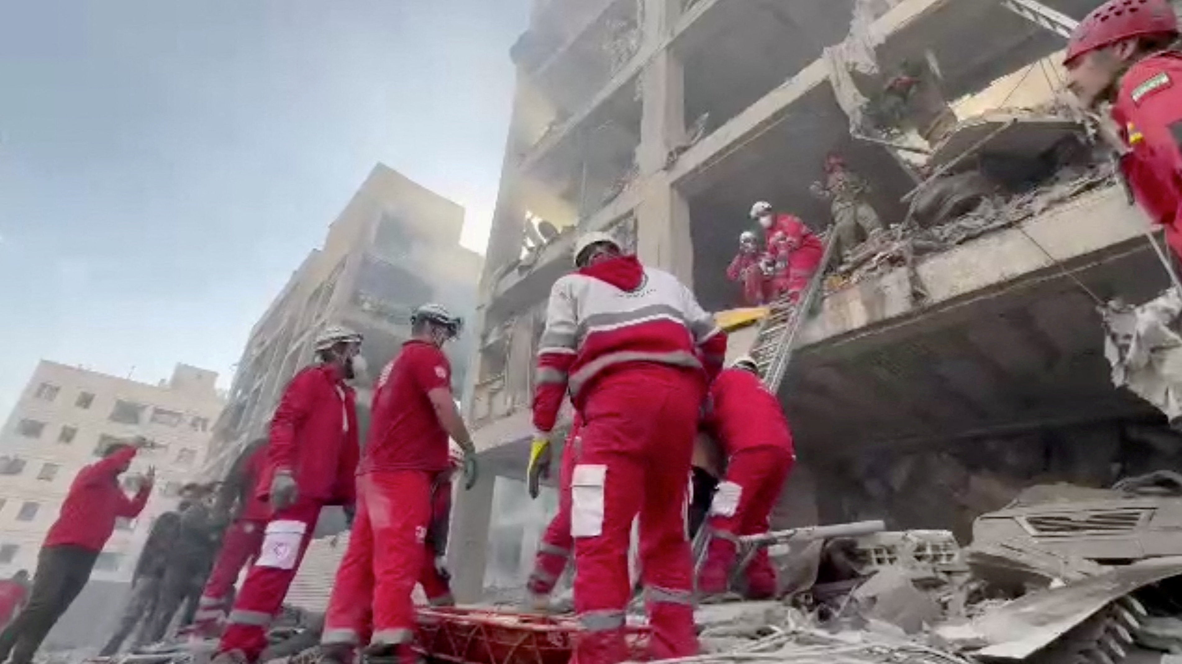 Rescuers work in the rubble of residential buildings after airstrikes, in the Resalat neighbourhood, in Tehran, Iran