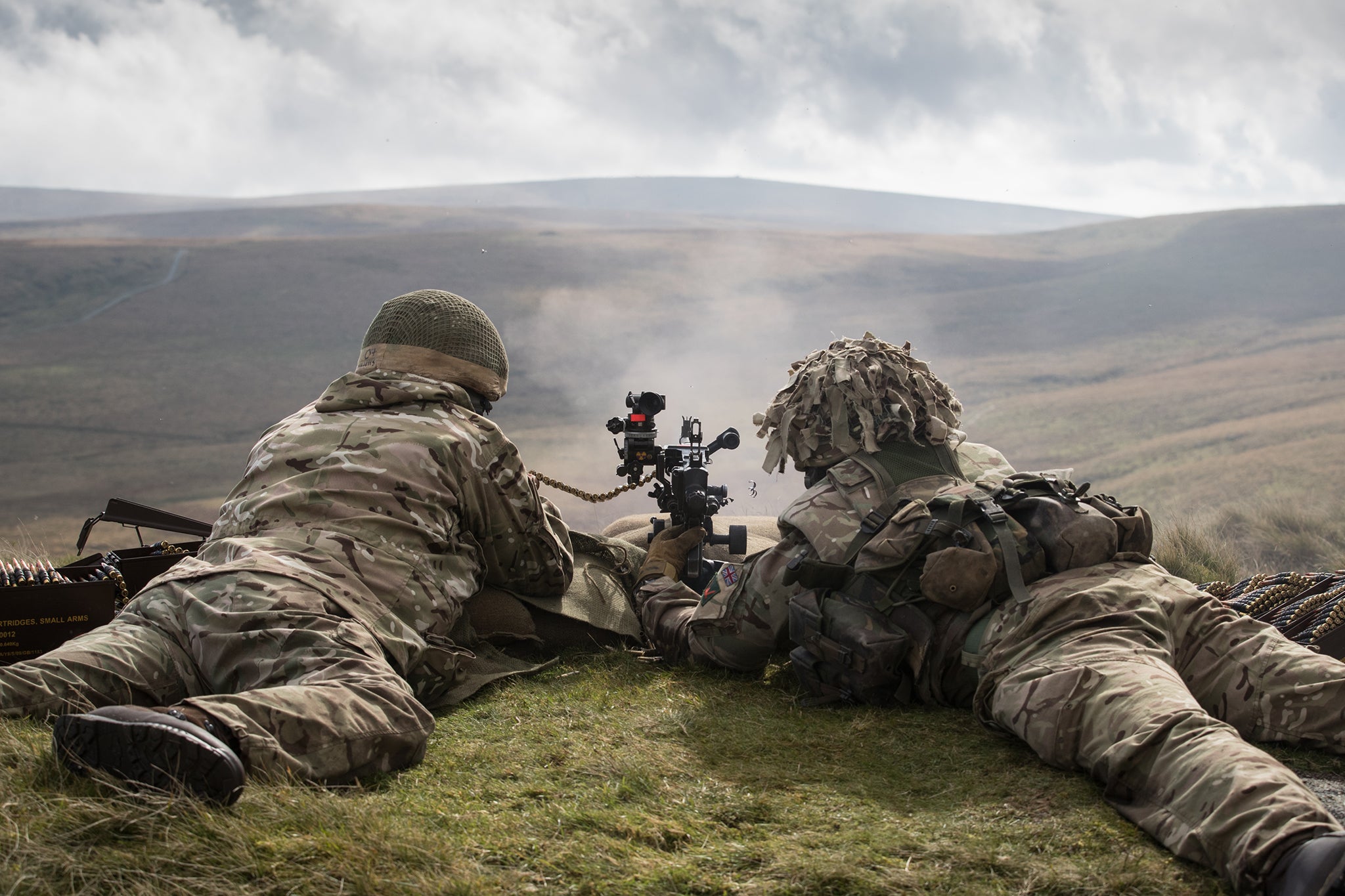 British reservists fire a machine gun on the range at Okehampton Camp, Dartmoor