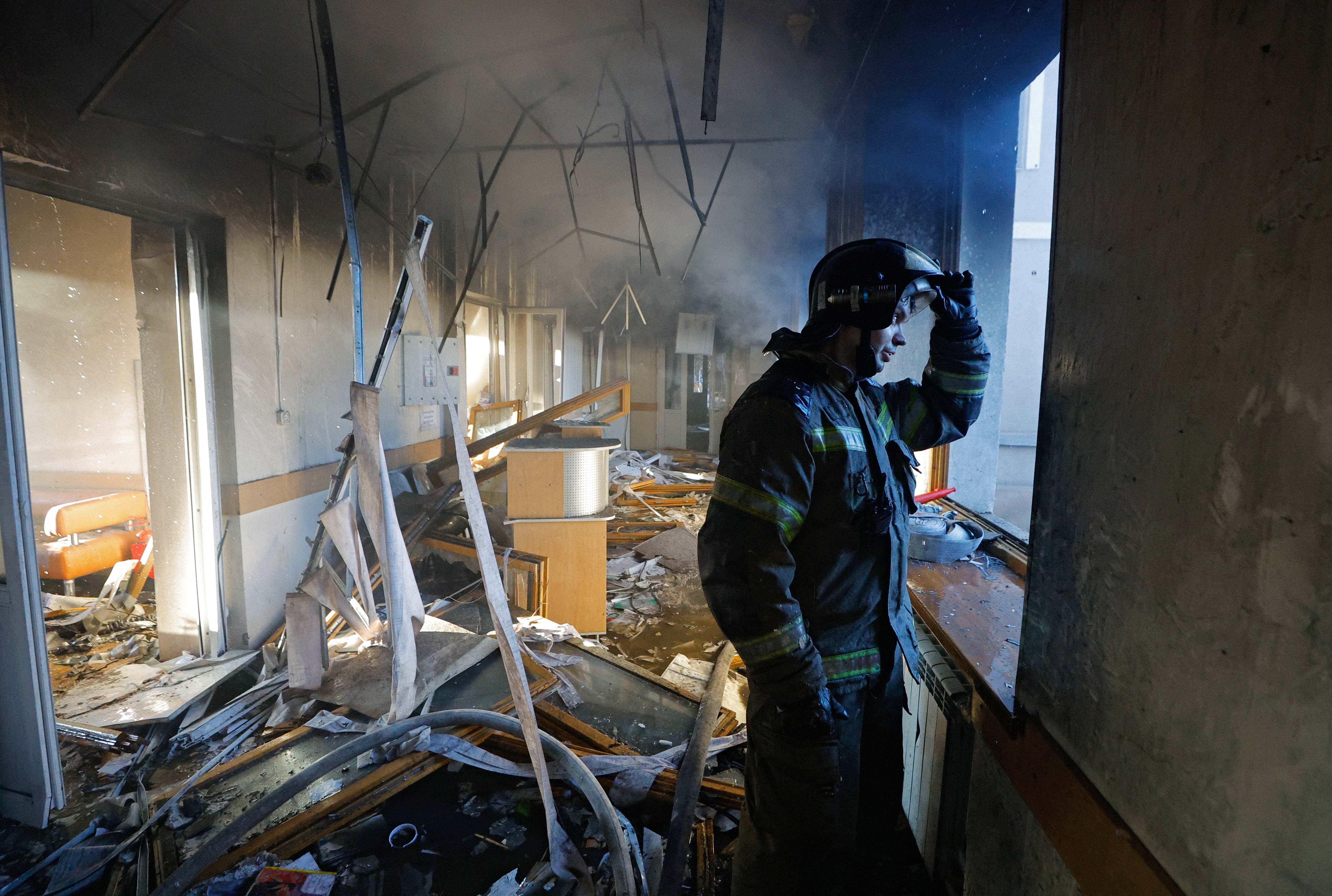 A firefighter works inside a building of a children's hospital, damaged by recent shelling that local Russian-installed authorities called a Ukrainian military strike, while the hospital was under maintenance with no patients inside, in the course of the Russia-Ukraine military conflict in Donetsk, a Russian-controlled city of Ukraine