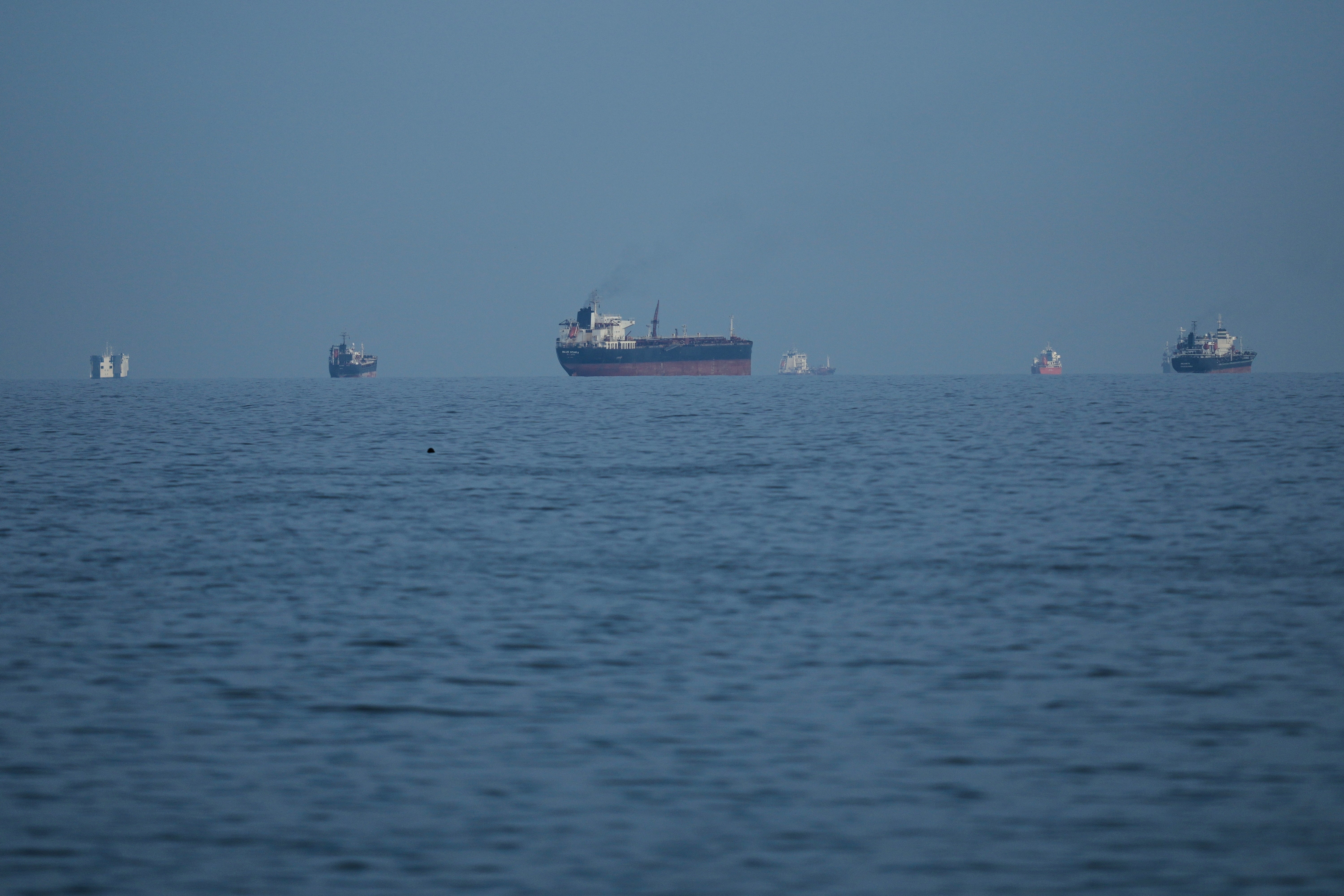 Oil tankers and cargo ships line up in the Strait of Hormuz