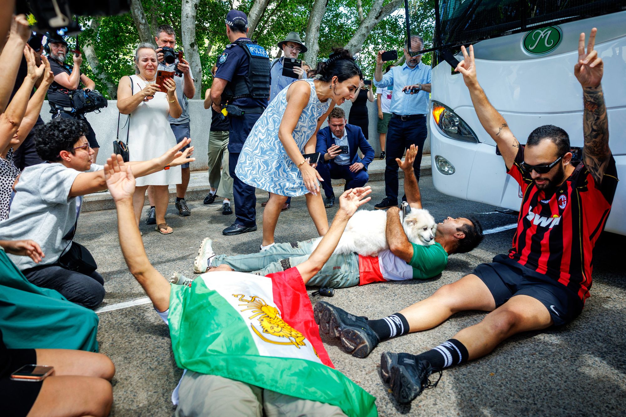 Members of the Iranian community in Australia block the path of a departing bus transporting members of the Iranian Women's Asia Cup football team to the airport, outside the Royal Pines Resort on the Gold Coast on March 10, 2026.