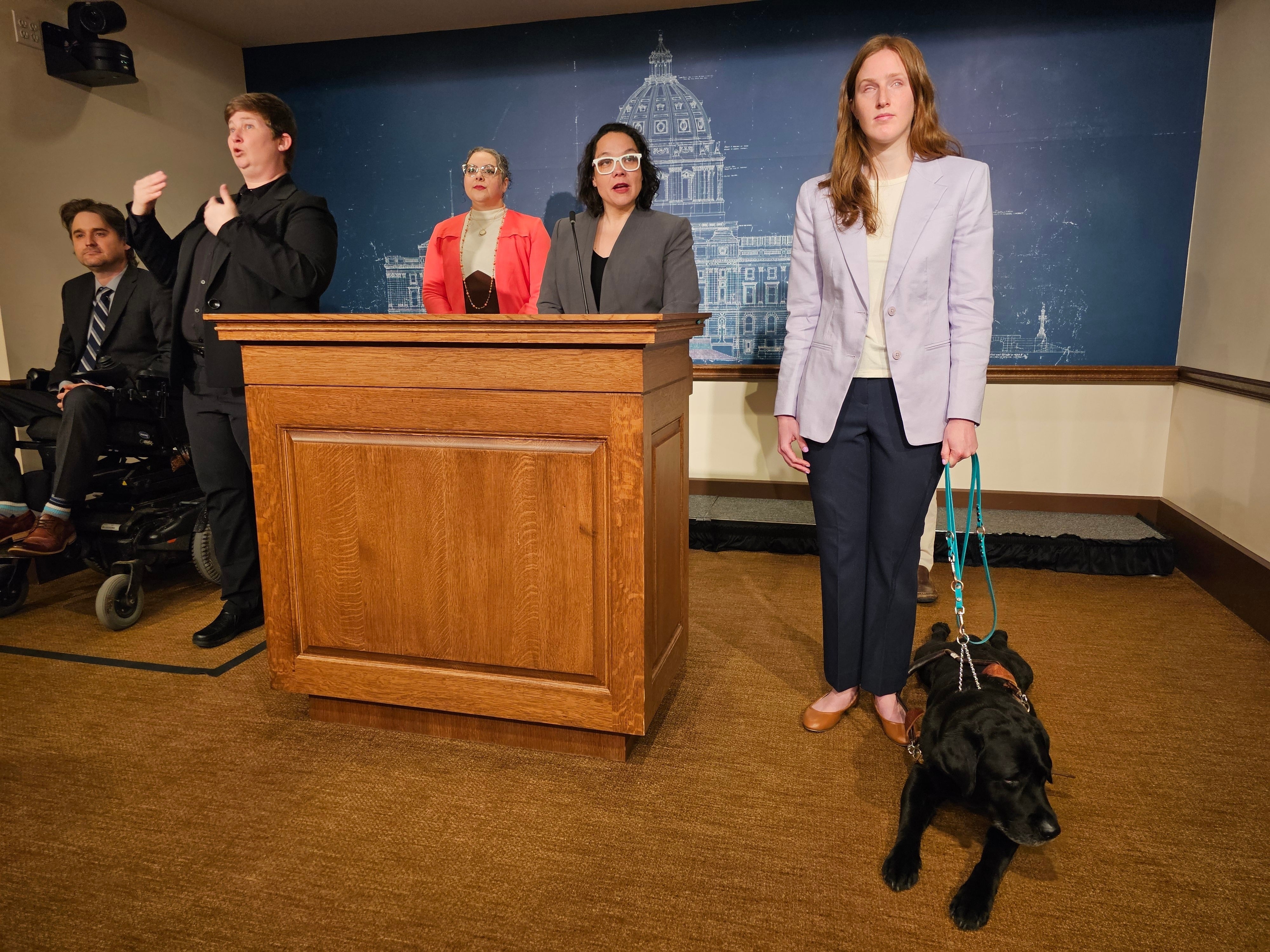 Speaking at a news conference, with her black Labrador quietly at her feet, Andres emphasized the profound importance of her service animal