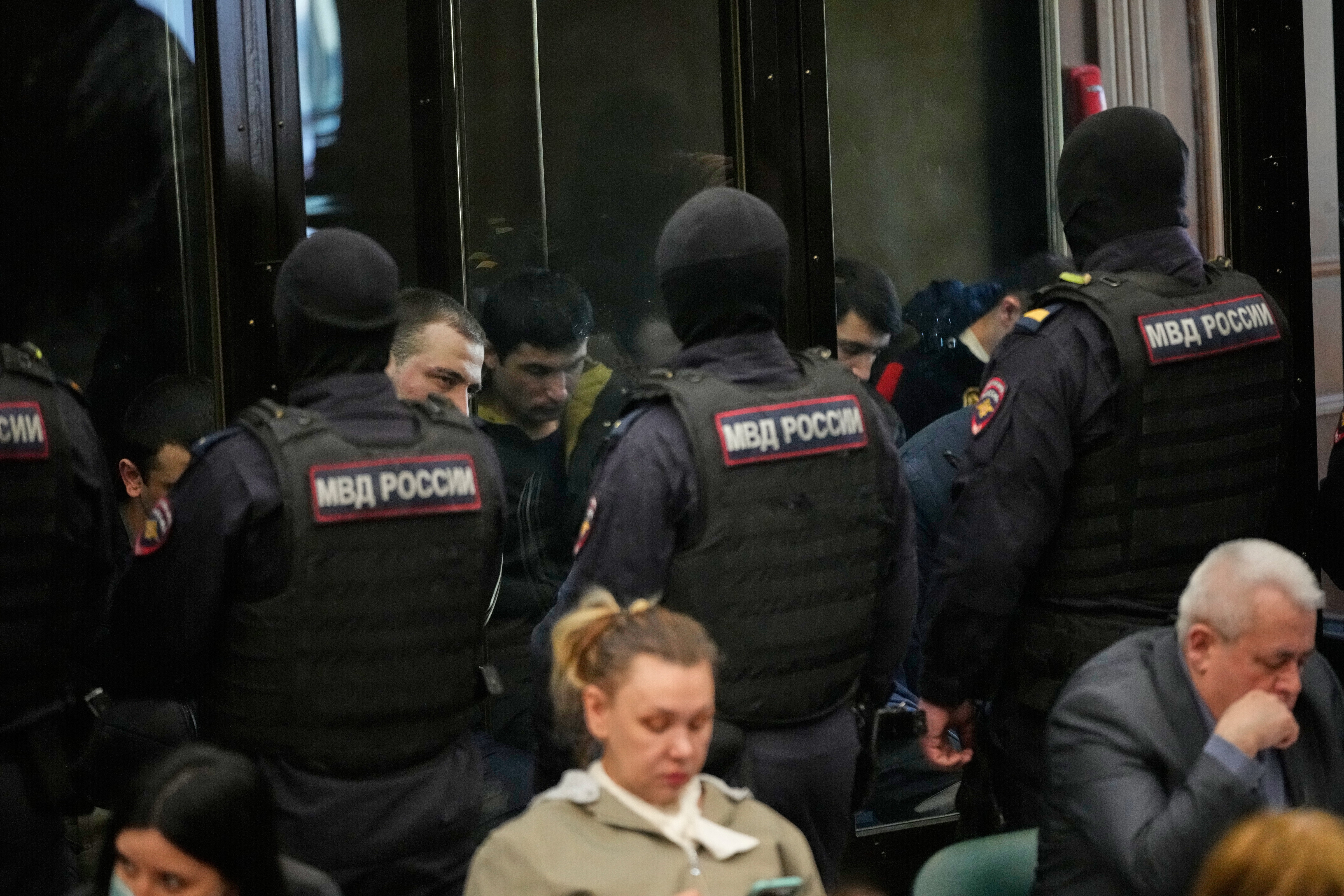 Men tried on the charges of involvement in a terror attack at the Crocus City Hall in March 2024 listen to the verdict in a glass cage at the Second Western District Military Court in Moscow, Russia.