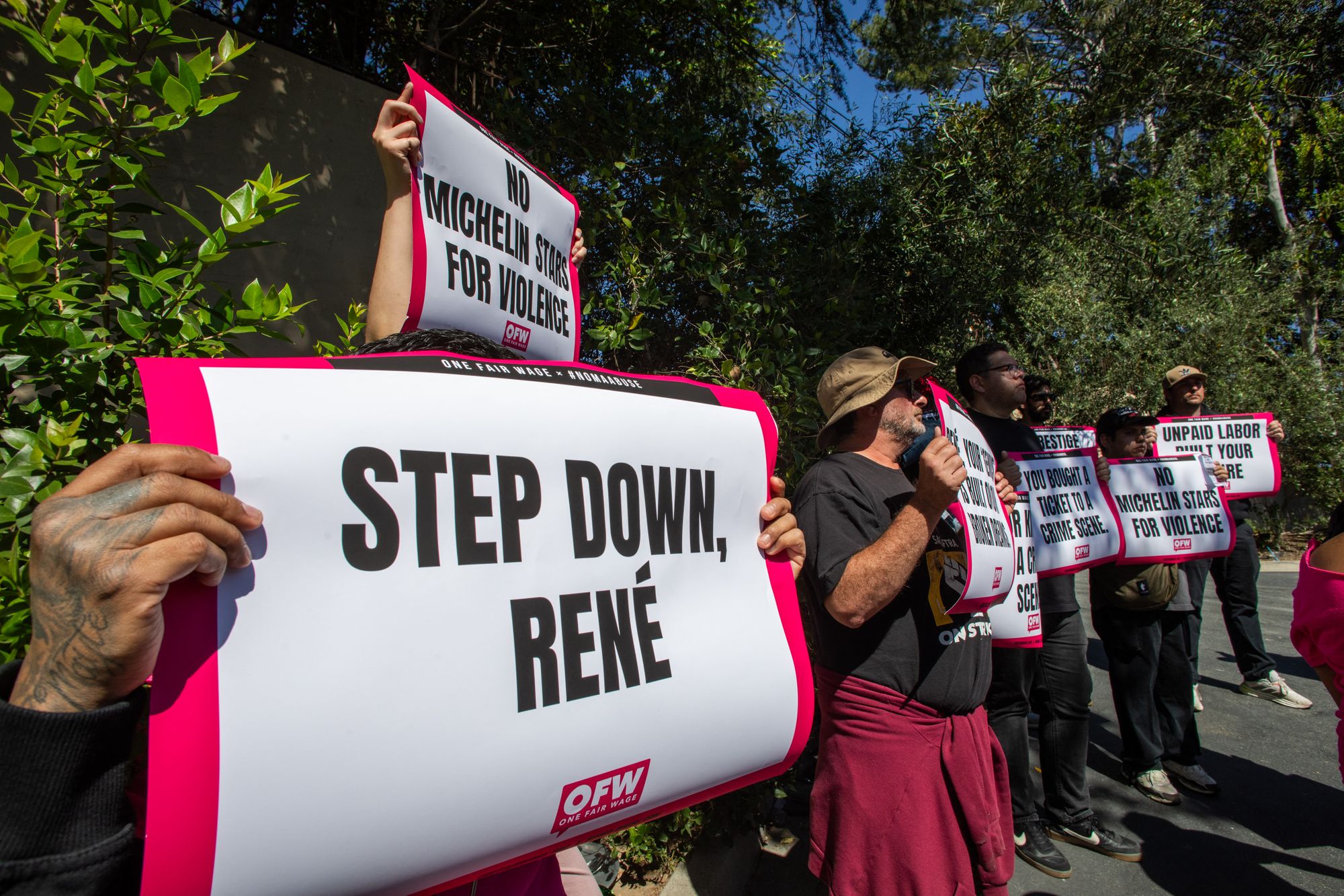 Activists and restaurant workers gather in front of Danish chef Rene Redzepi's Noma Restaurant's $1,500-per-seat pop-up in Los Angeles, on Wednesday