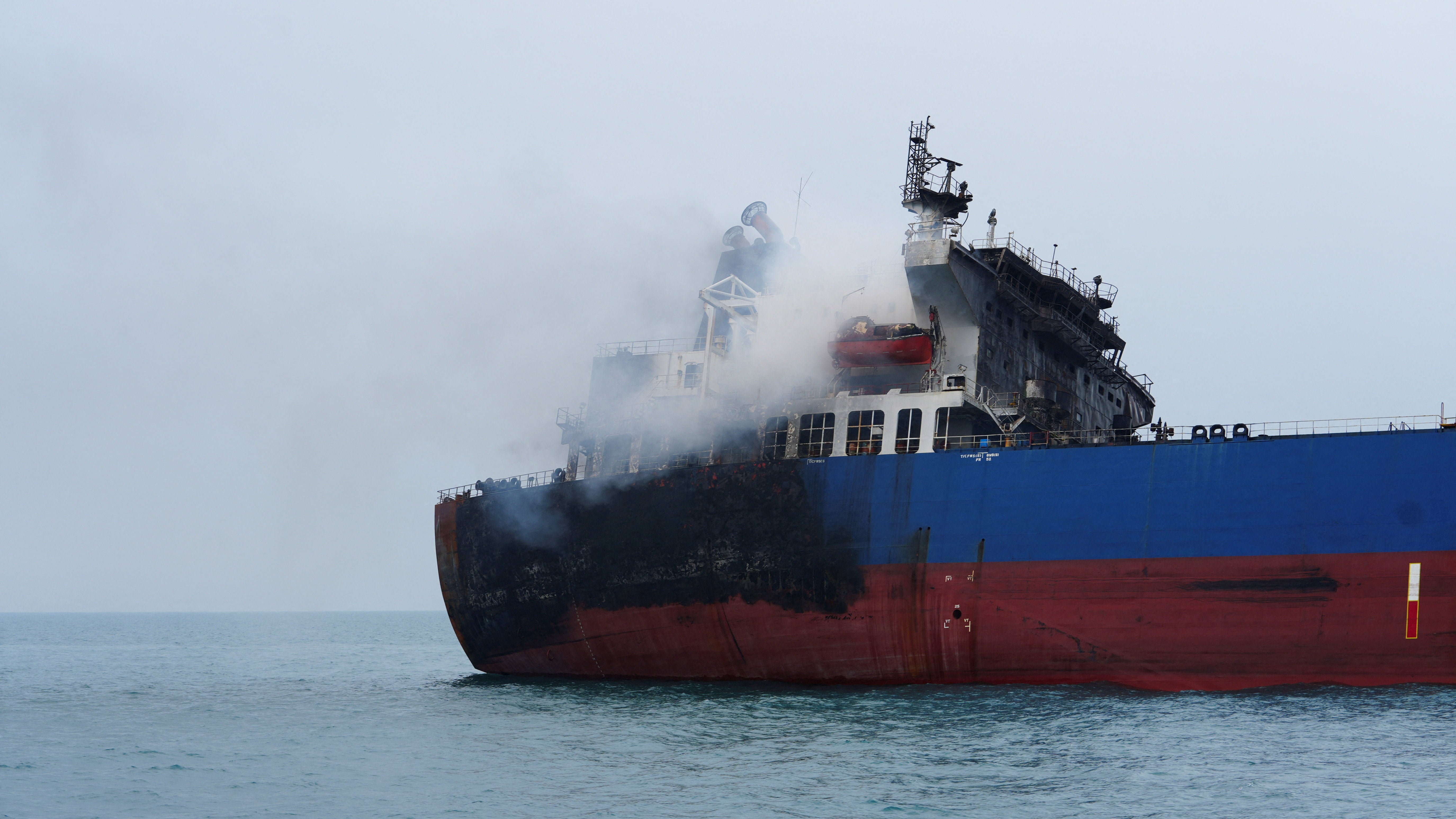 A foreign tanker carrying Iraqi fuel oil damaged after catching fire in Iraq's territorial waters, following unidentified attacks that targeted two foreign tankers