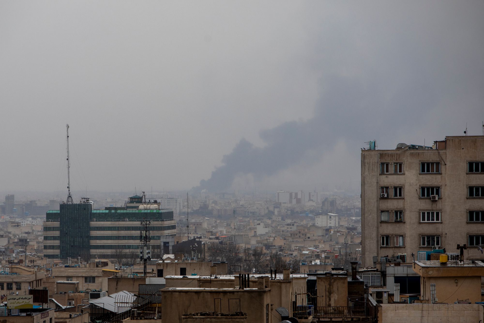 Smoke rises following an airstrike at the same time as a Quds Day demonstration in Tehran on Friday