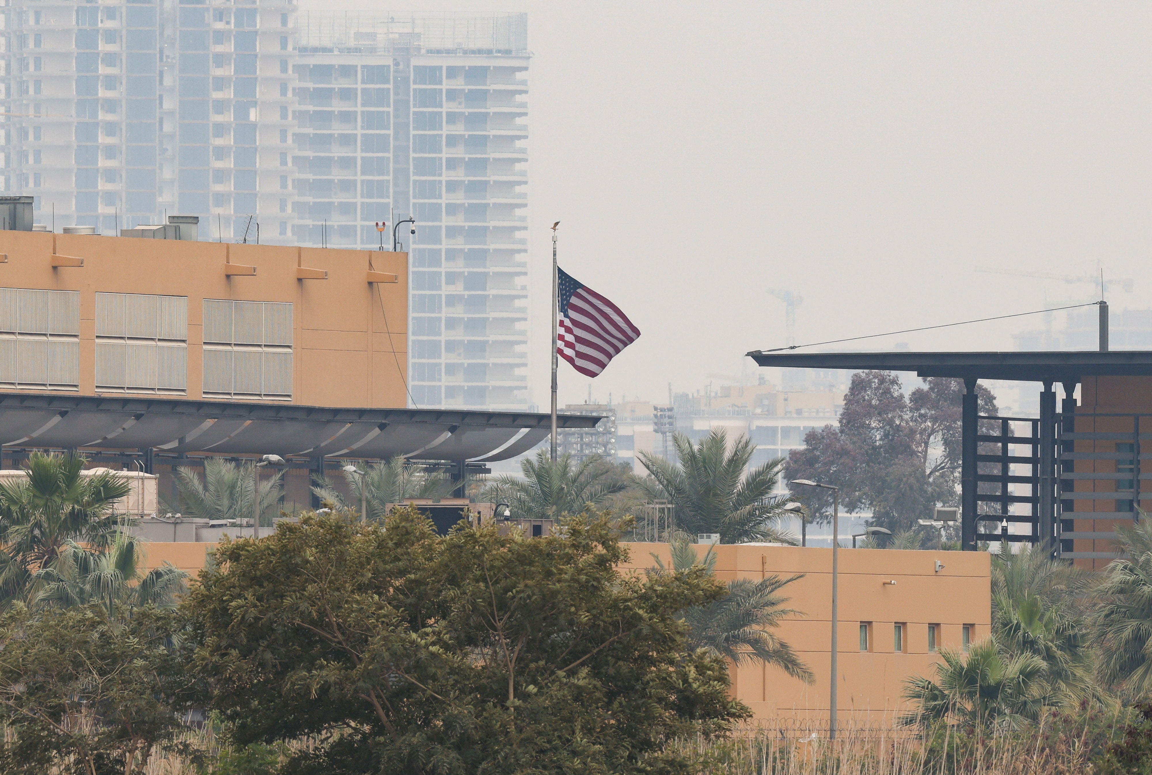 The US flag flies at the US Embassy, after Iraqi security sources said the embassy was hit in a missile attack, in Baghdad, Iraq, March 14, 2026. REUTERS/Ahmed Saad