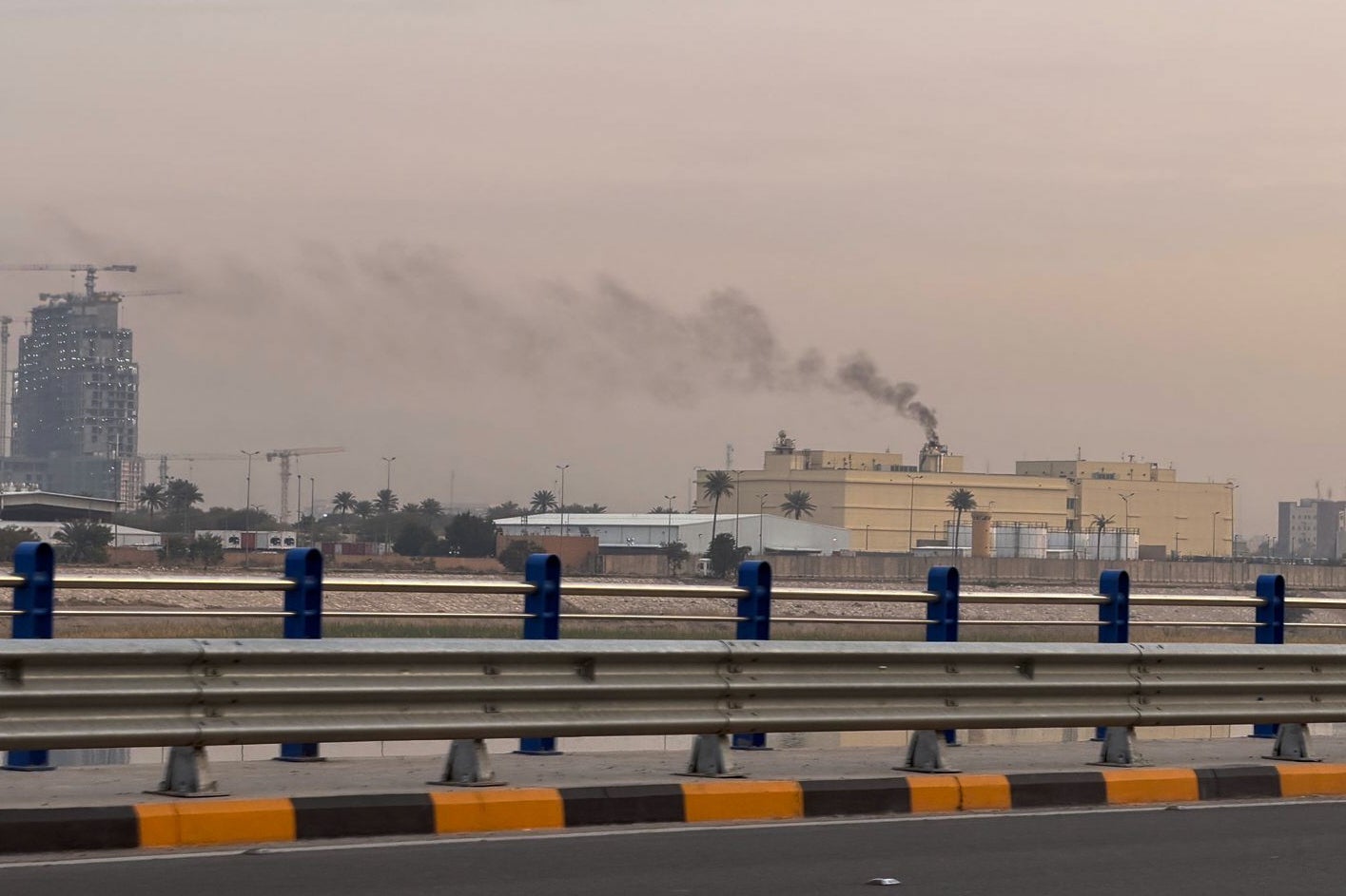Smoke rises from the US embassy building in Baghdad, Iraq, Saturday, March 14, 2026. (AP Photo/Ali Jabar)