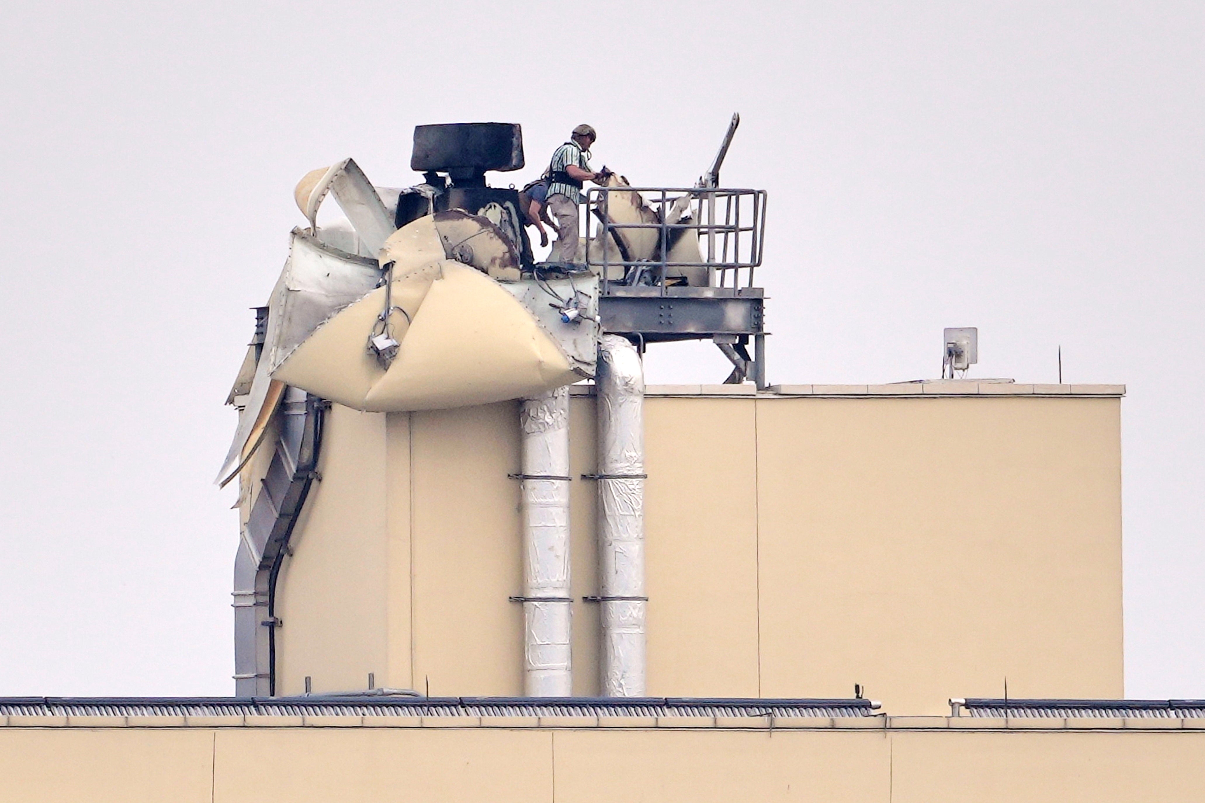 US embassy personnel inspect the damage caused by a bombing in Baghdad, Saturday, March 14, 2026. (AP Photo/Hadi Mizban)