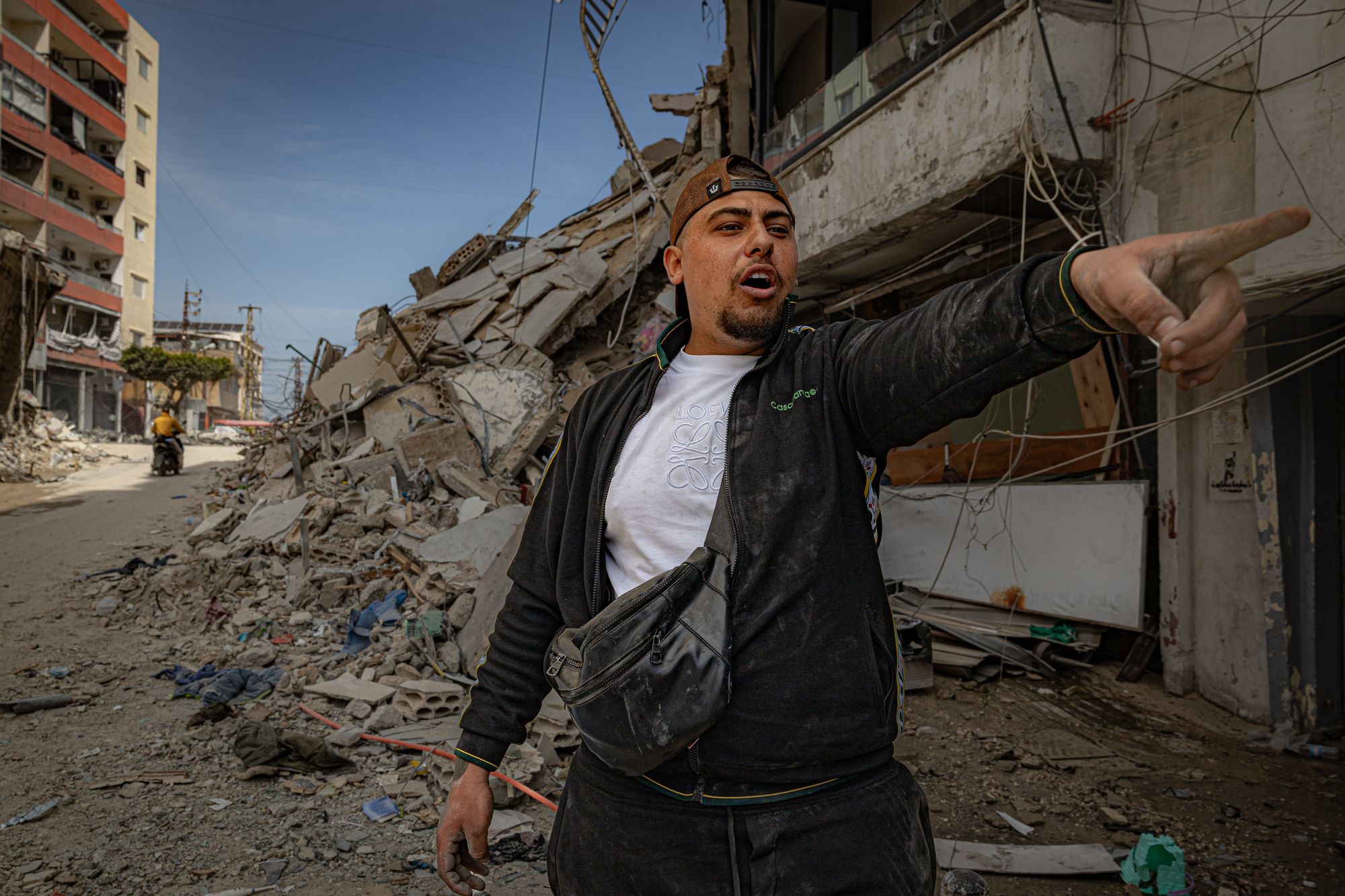 Mohammed (not related to Iman), by the destroyed remains of his building in Tyre, which was damaged by Israeli airstrikes in 2024 and this month