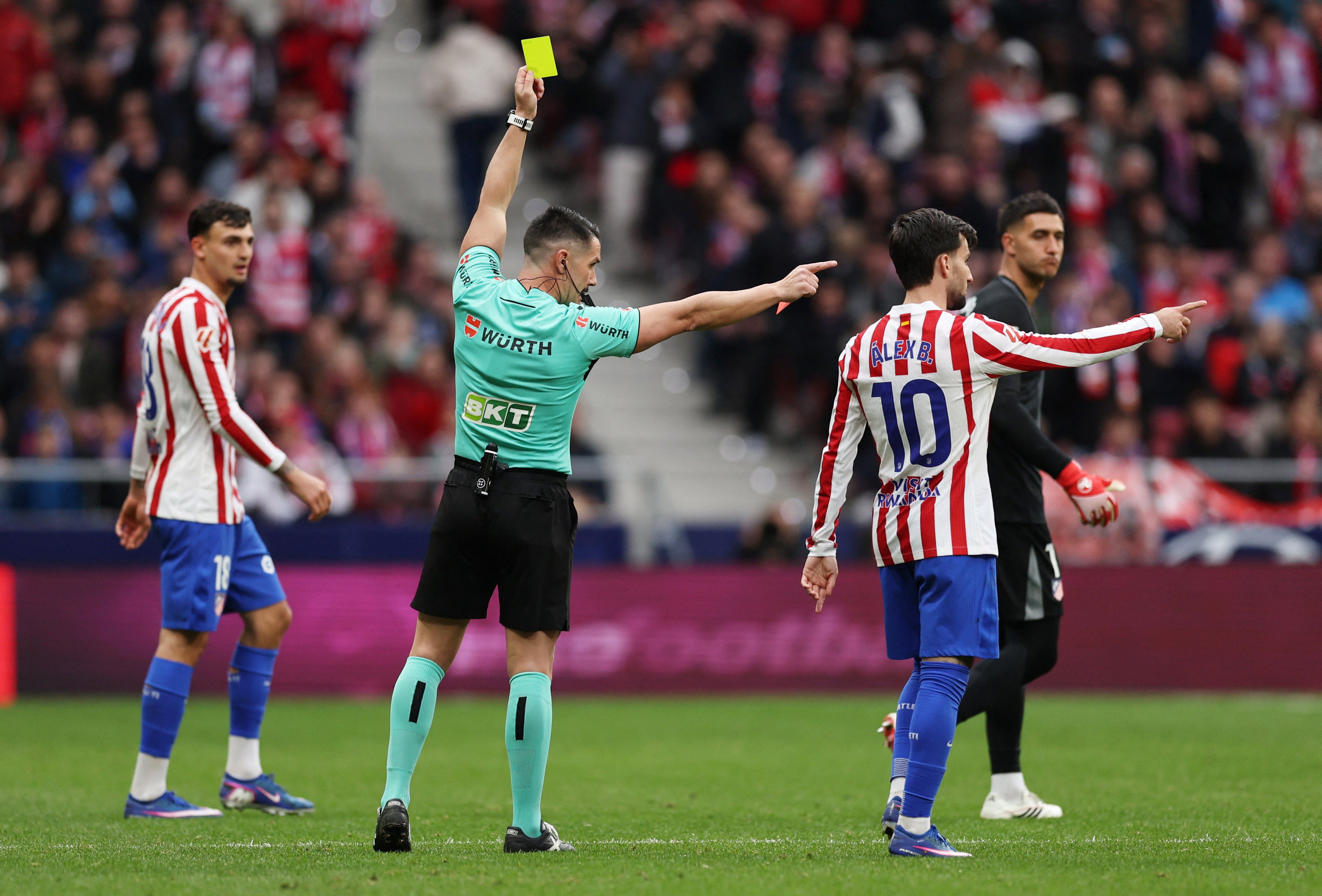Atletico Madrid's Alexander Sorloth receives a yellow card