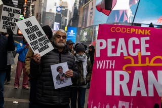 Banners raised read "no blood for oil from Middle East to Latin America'