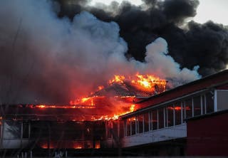 Fire and smoke rise at the site of a Russian missile and drone strike, amid Russia's attack on Ukraine, in the town of Brovary, in Kyiv region