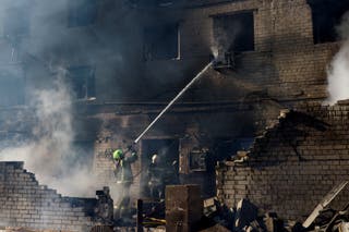 Firefighters work at the site of a Russian missile and drone strike, amid Russia's attack on Ukraine, in the town of Brovary, Kyiv region