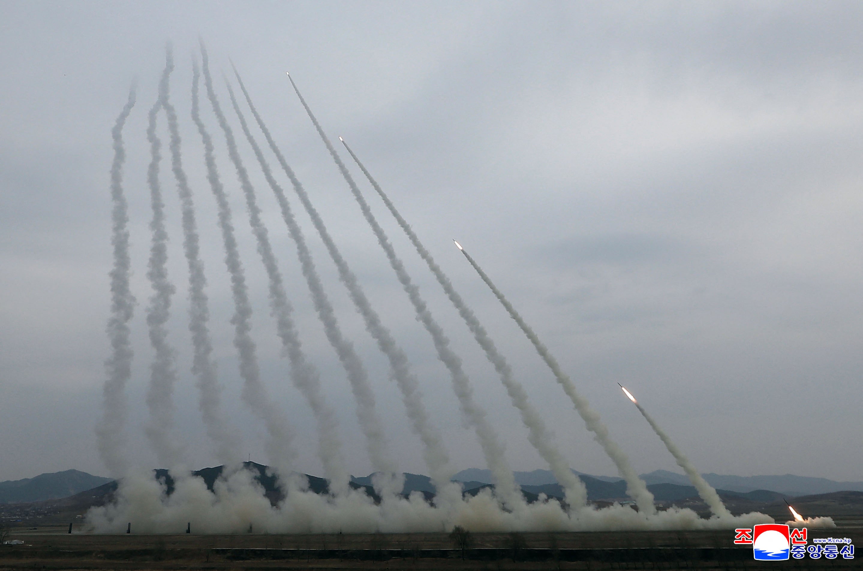 This picture taken on March 14, 2026 and released by North Korea's official Korean Central News Agency (KCNA) via KNS on March 15, 2026 shows a training exercise of North Korean Army's 600mm-calibre ultra-precision multiple rocket launchers, at an undisclosed location in North Kore